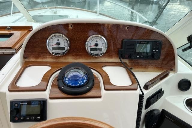 Dashboard of 2018 Hunt Yachts Harrier 25 with compass, gauges, and navigation equipment.
