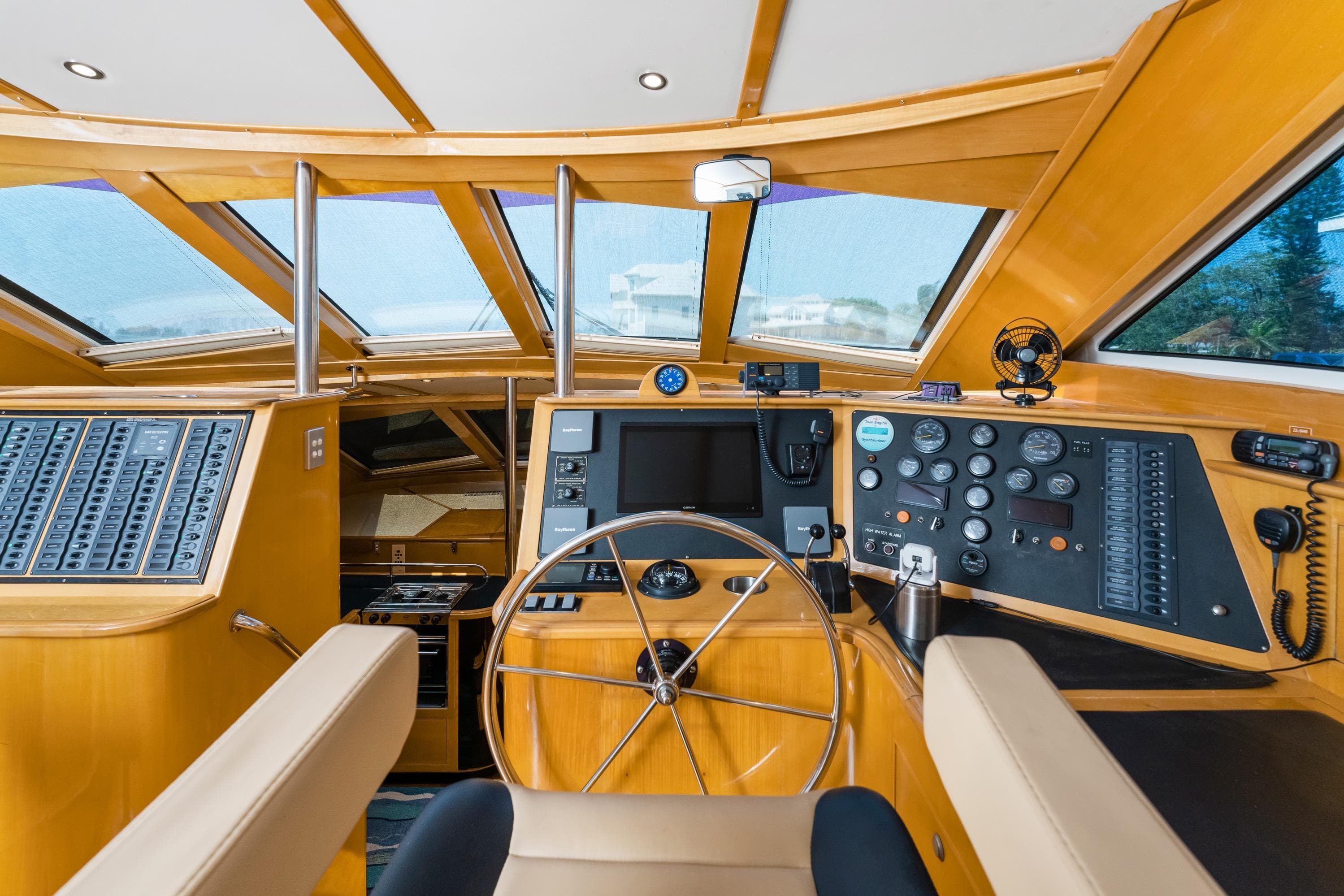 Interior helm of 2000 Jutson 46 LRC yacht with modern navigation equipment and wooden finish.