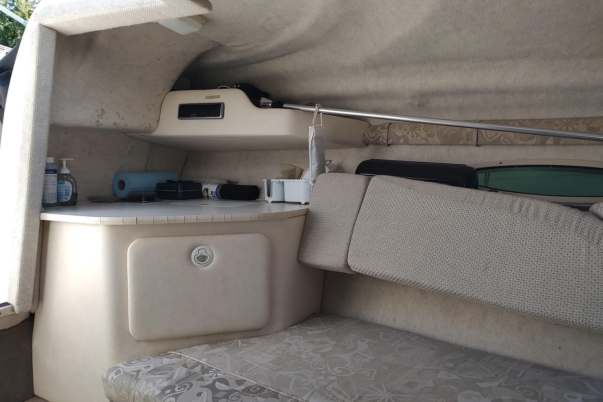 Interior cabin of 2004 Sea Ray 215 Weekender boat with seating and storage.
