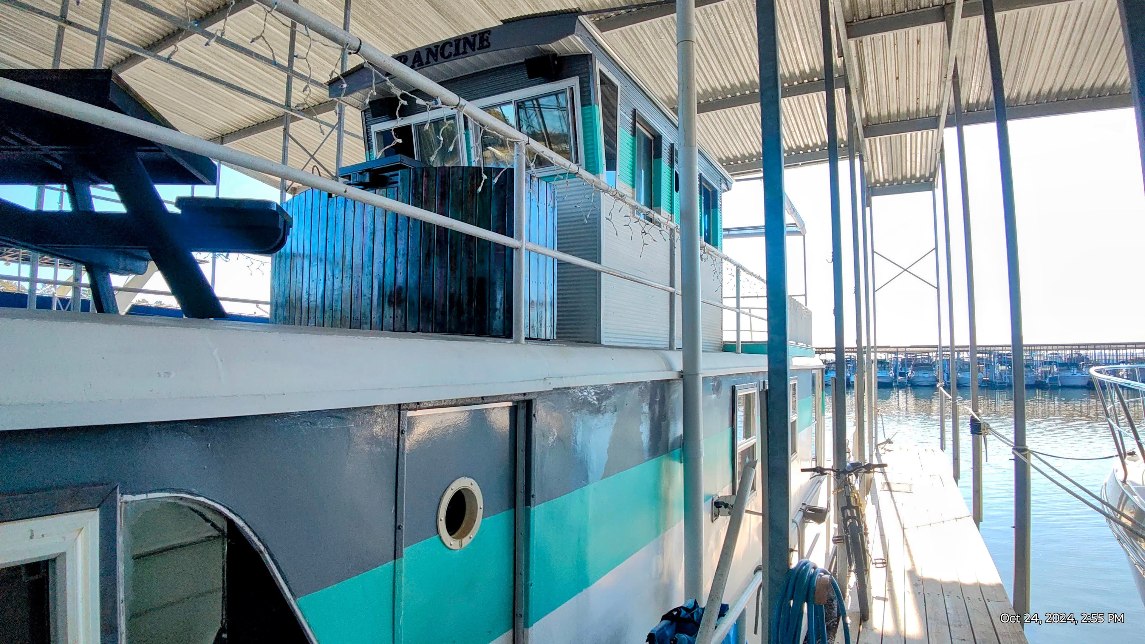 1964 Kelly 62' boat docked in harbor, side view.