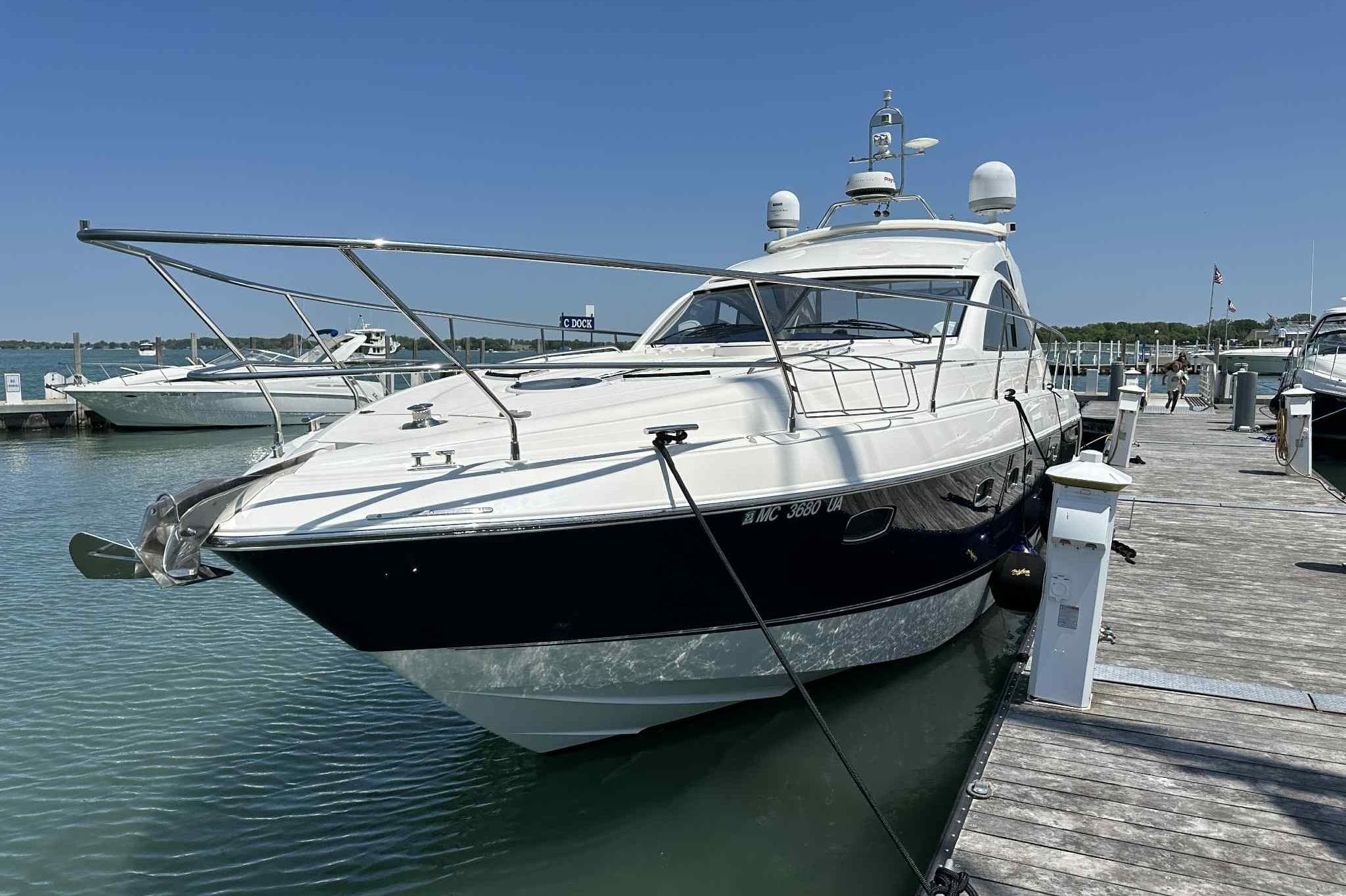 2007 Fairline Targa 47 GT yacht docked at marina under clear blue sky.
