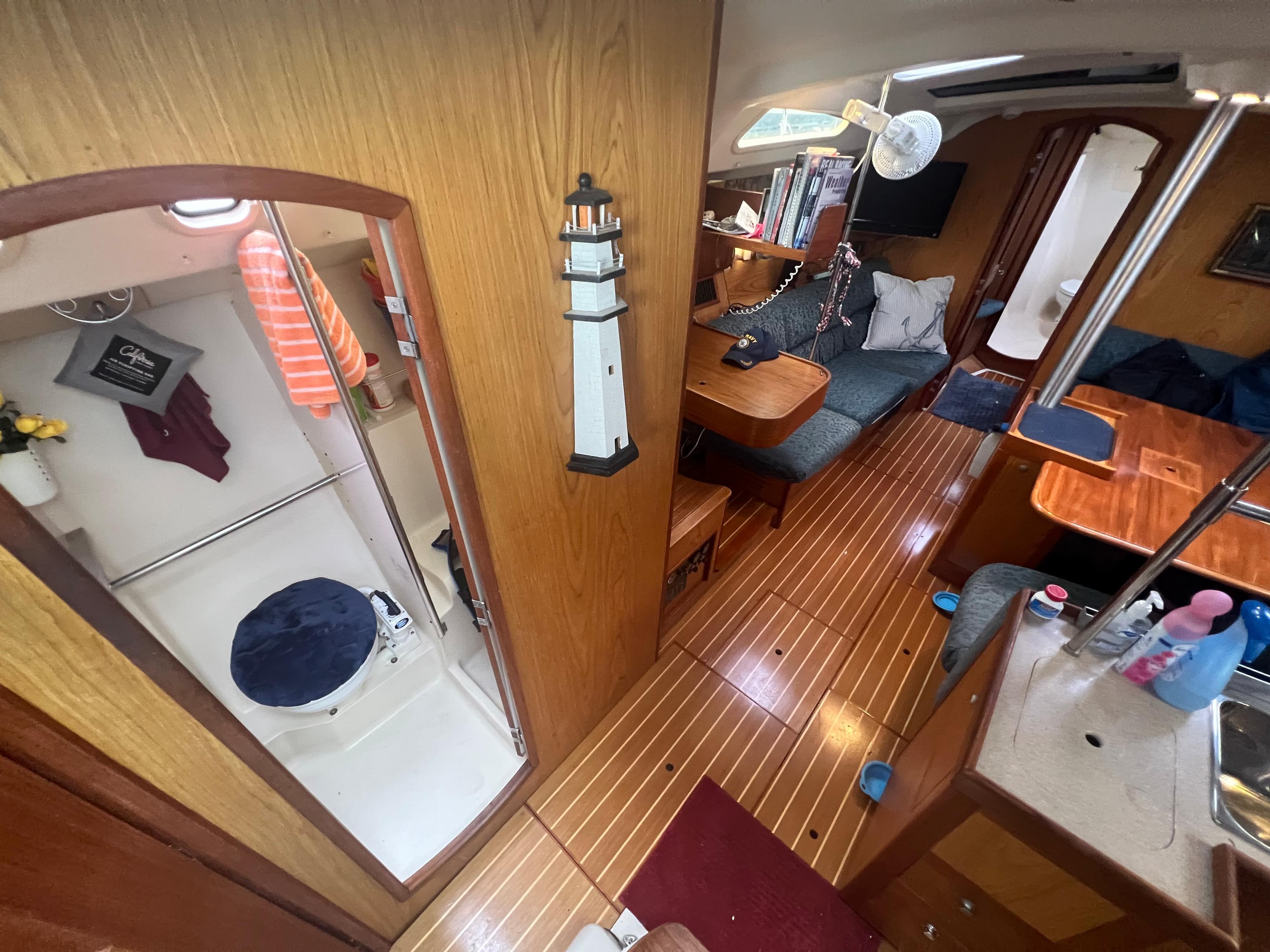Interior of 2000 Hunter 410 sailboat with cozy seating and compact bathroom.