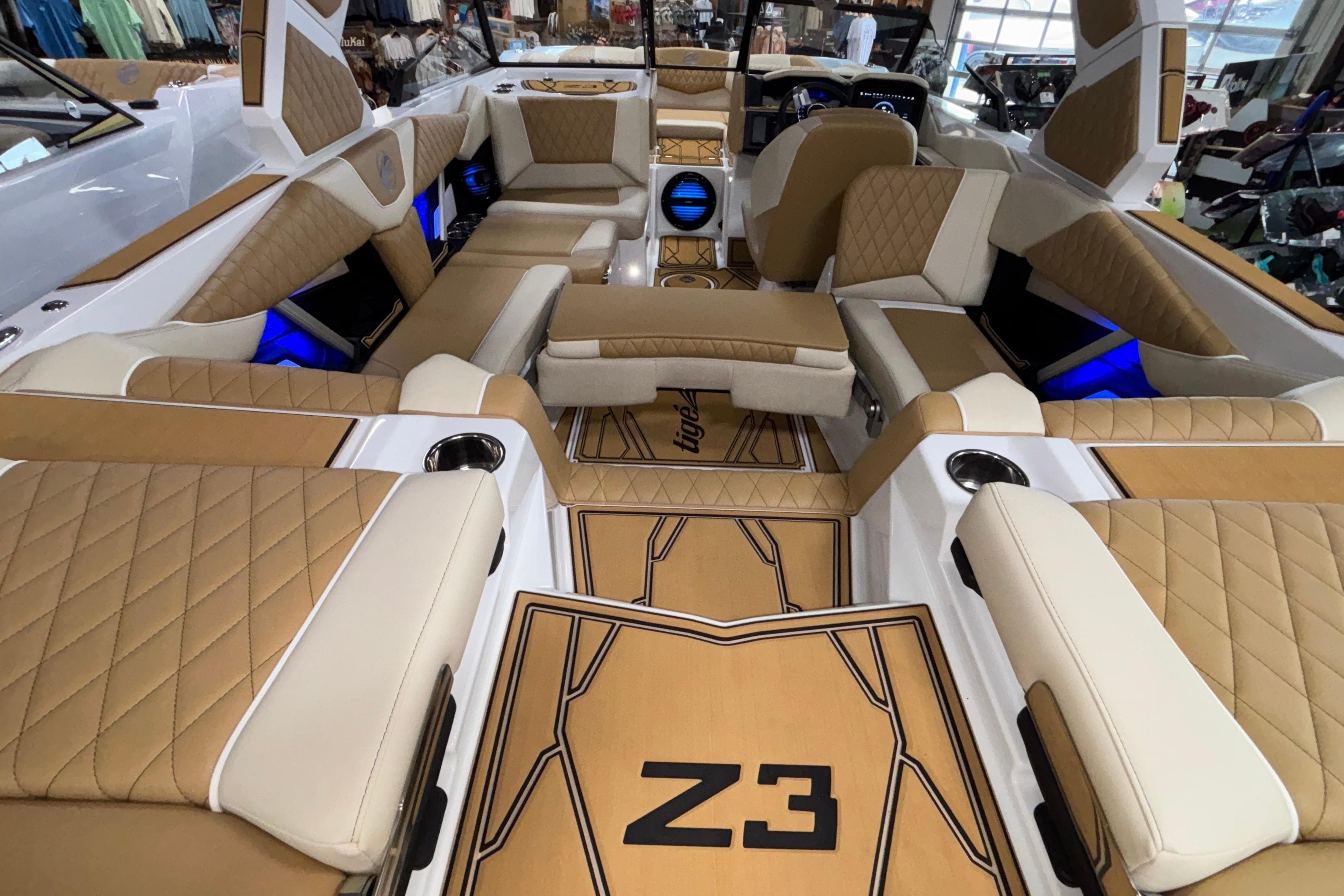 Luxurious interior of 2026 Tigé Z3 boat with tan and white seating, blue LED lighting.