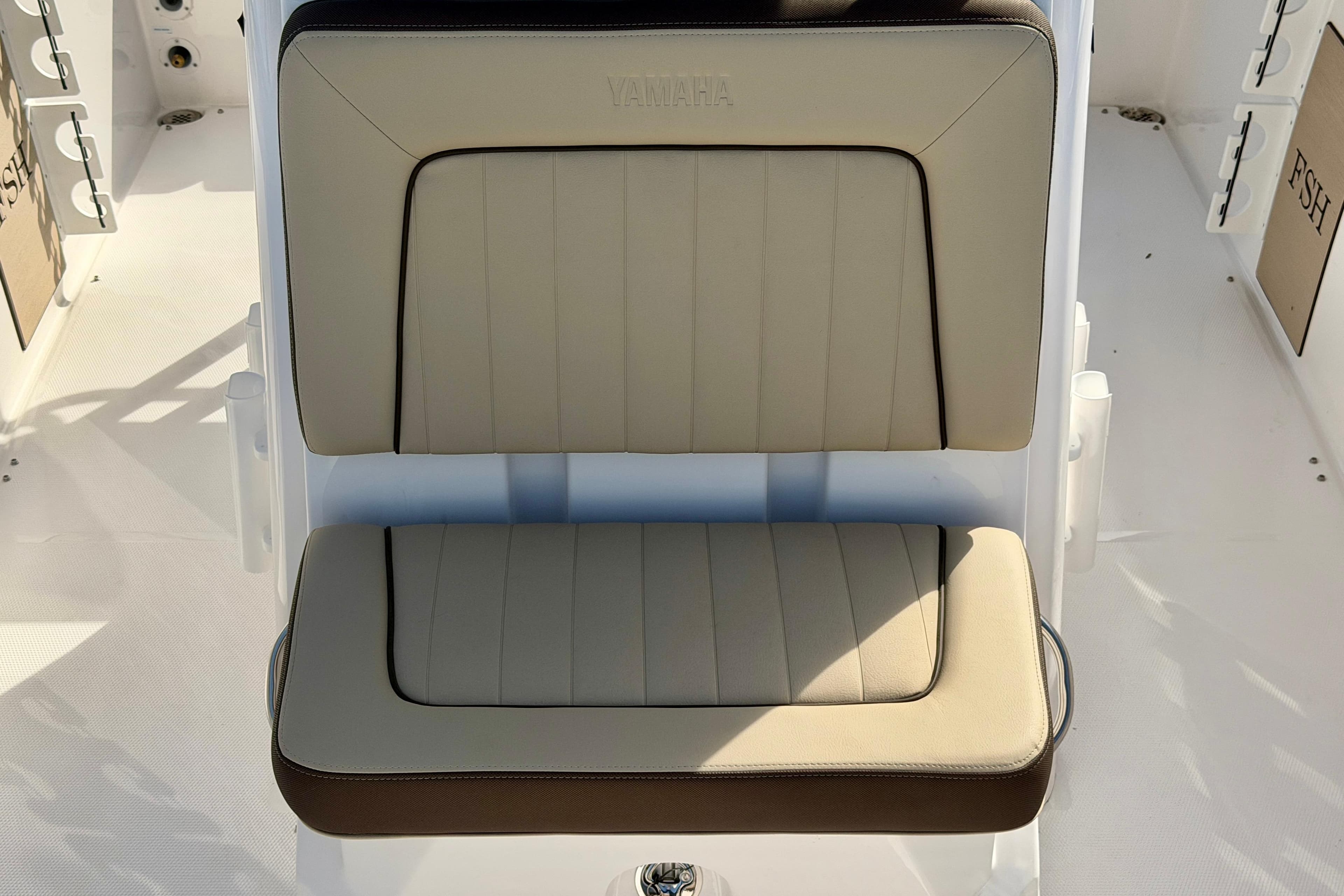 2026 Yamaha Boats 255 FSH Sport H seat, beige and brown upholstery, sleek design.