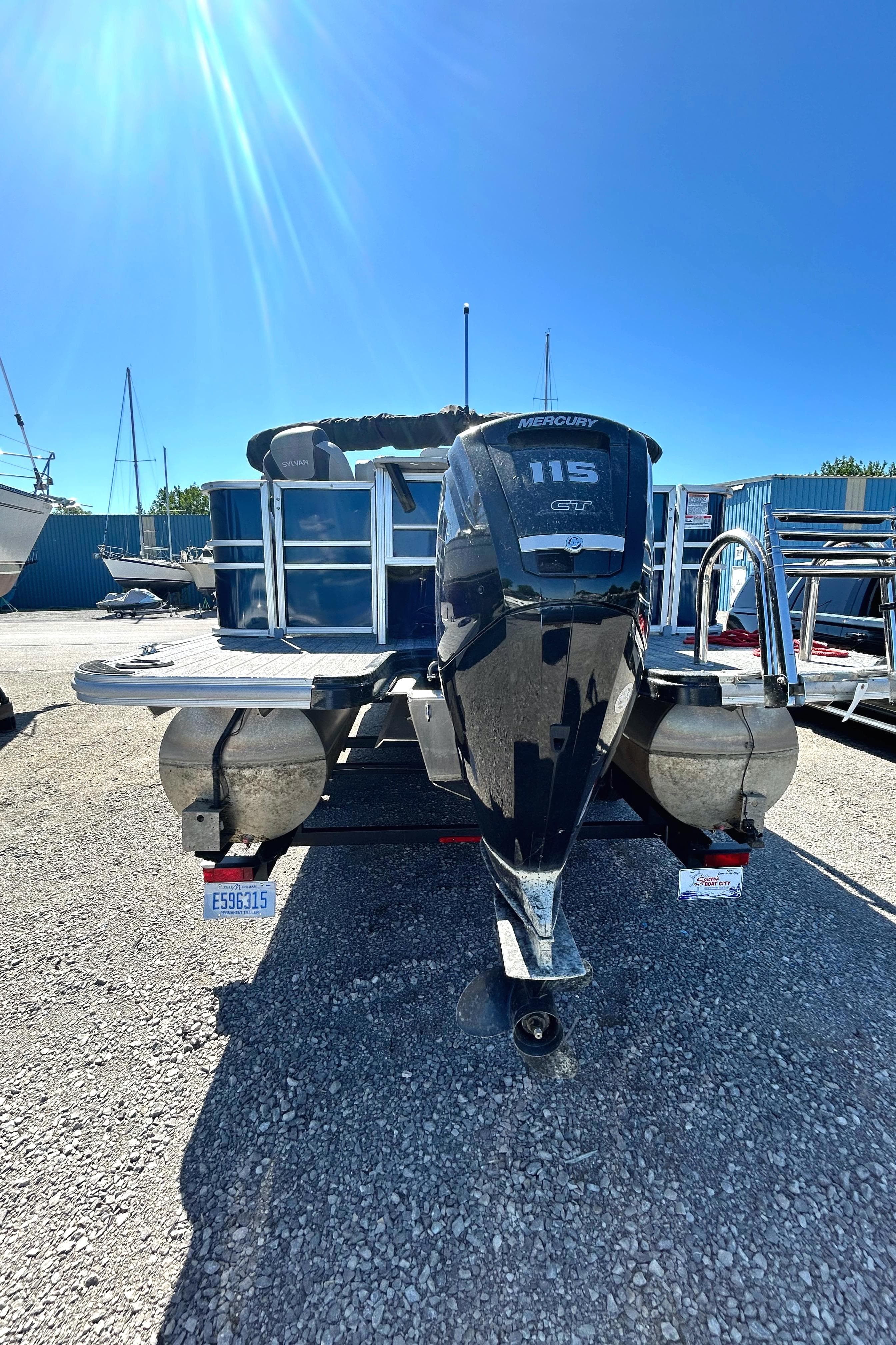 2022 Sylvan L3 Party Fish pontoon boat with 115 HP motor in a marina.
