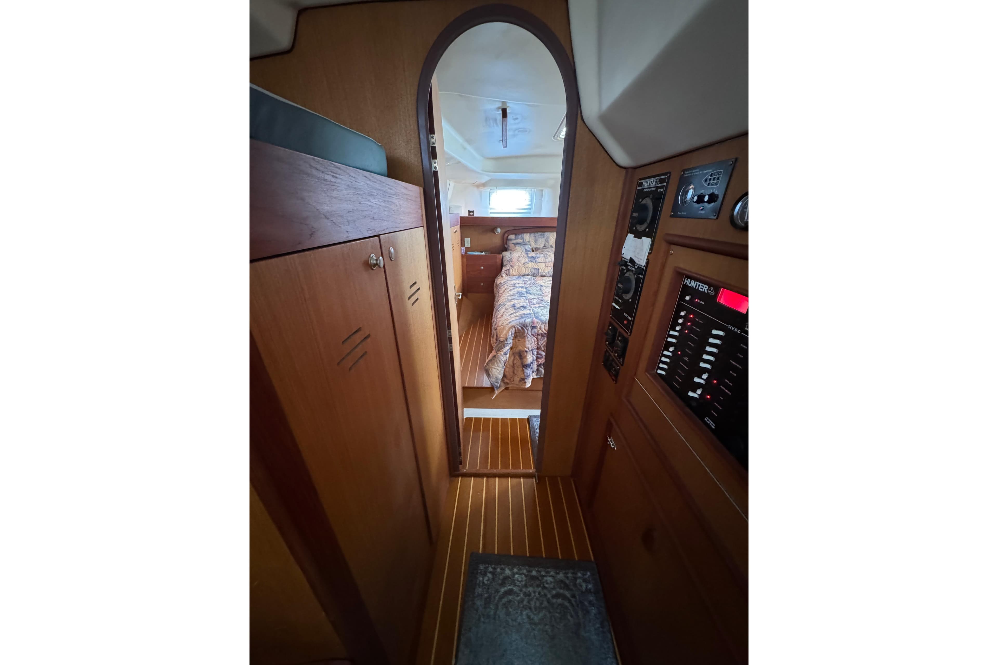 Interior view of 1999 Hunter Passage 420 sailboat, featuring wood paneling and cozy cabin.