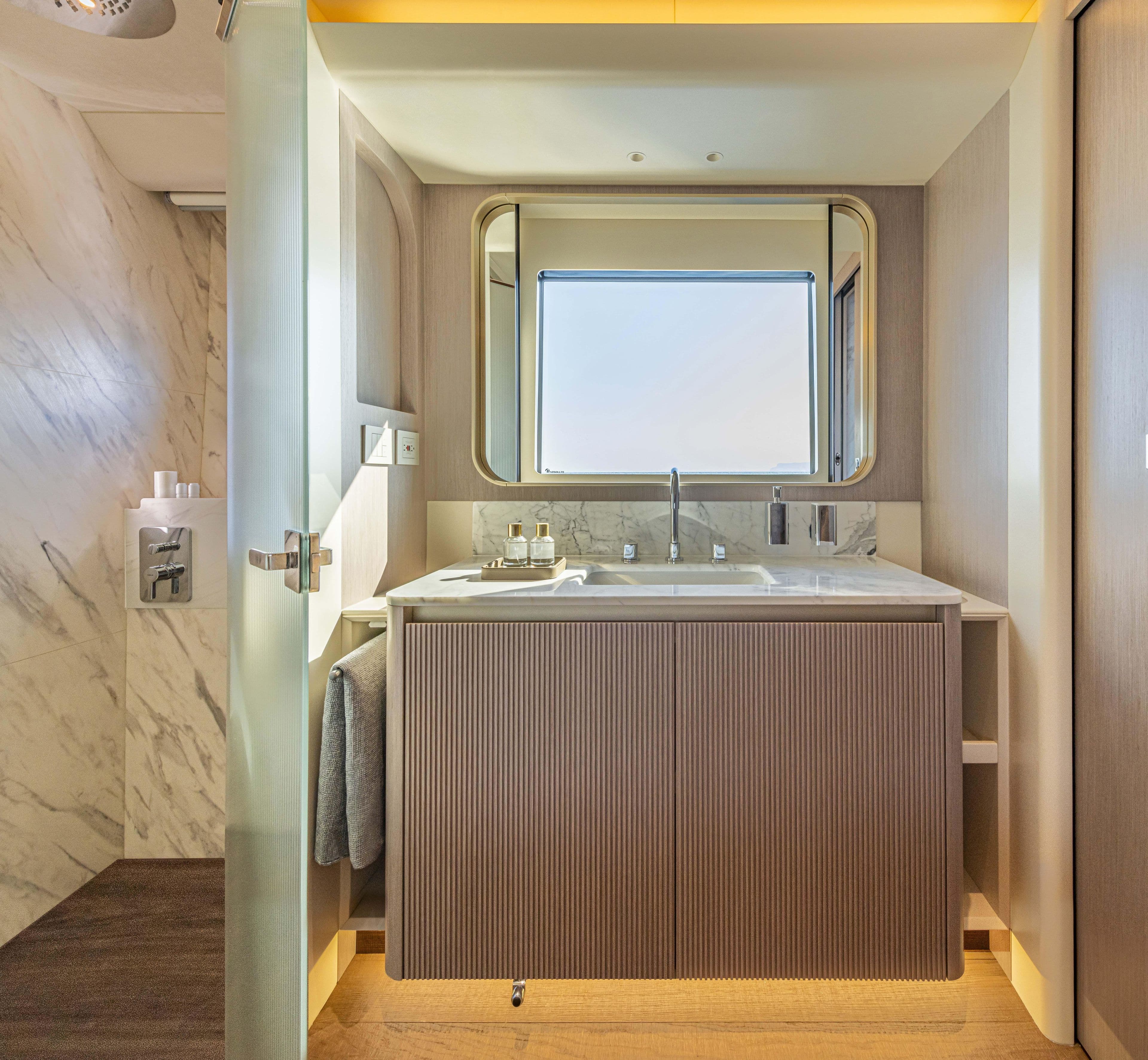 Luxurious bathroom interior on 2026 Absolute 70' Navetta yacht, featuring modern sink and elegant design.