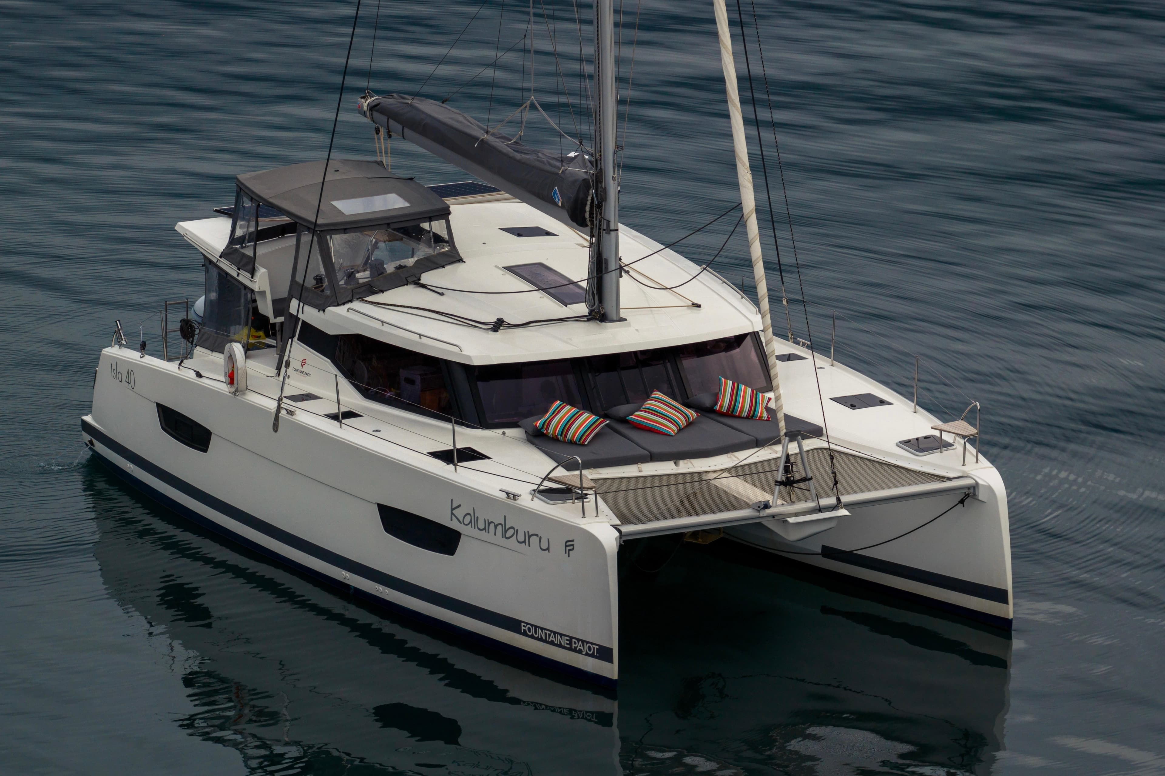 2022 Fountaine Pajot Isla 40 catamaran on calm water, featuring modern design and striped cushions.