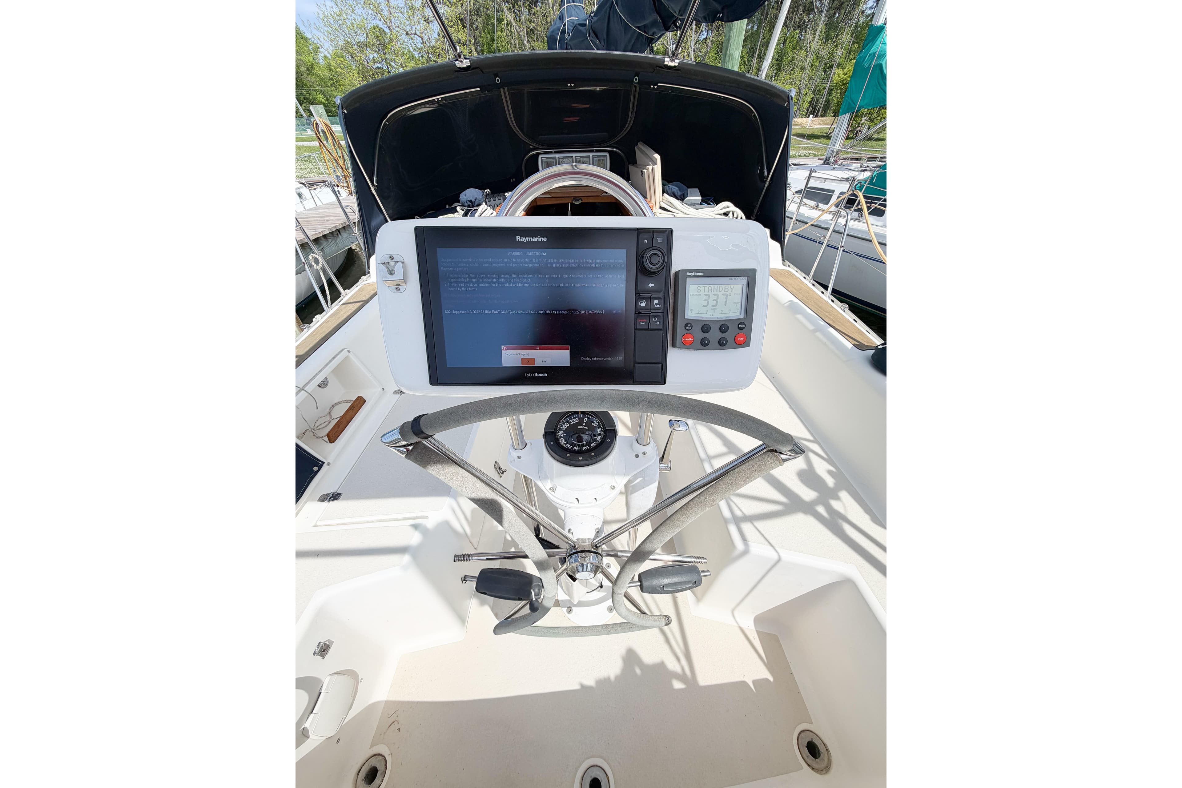 Cockpit of 2001 Caliber 40LRC sailboat with navigation equipment and steering wheel.