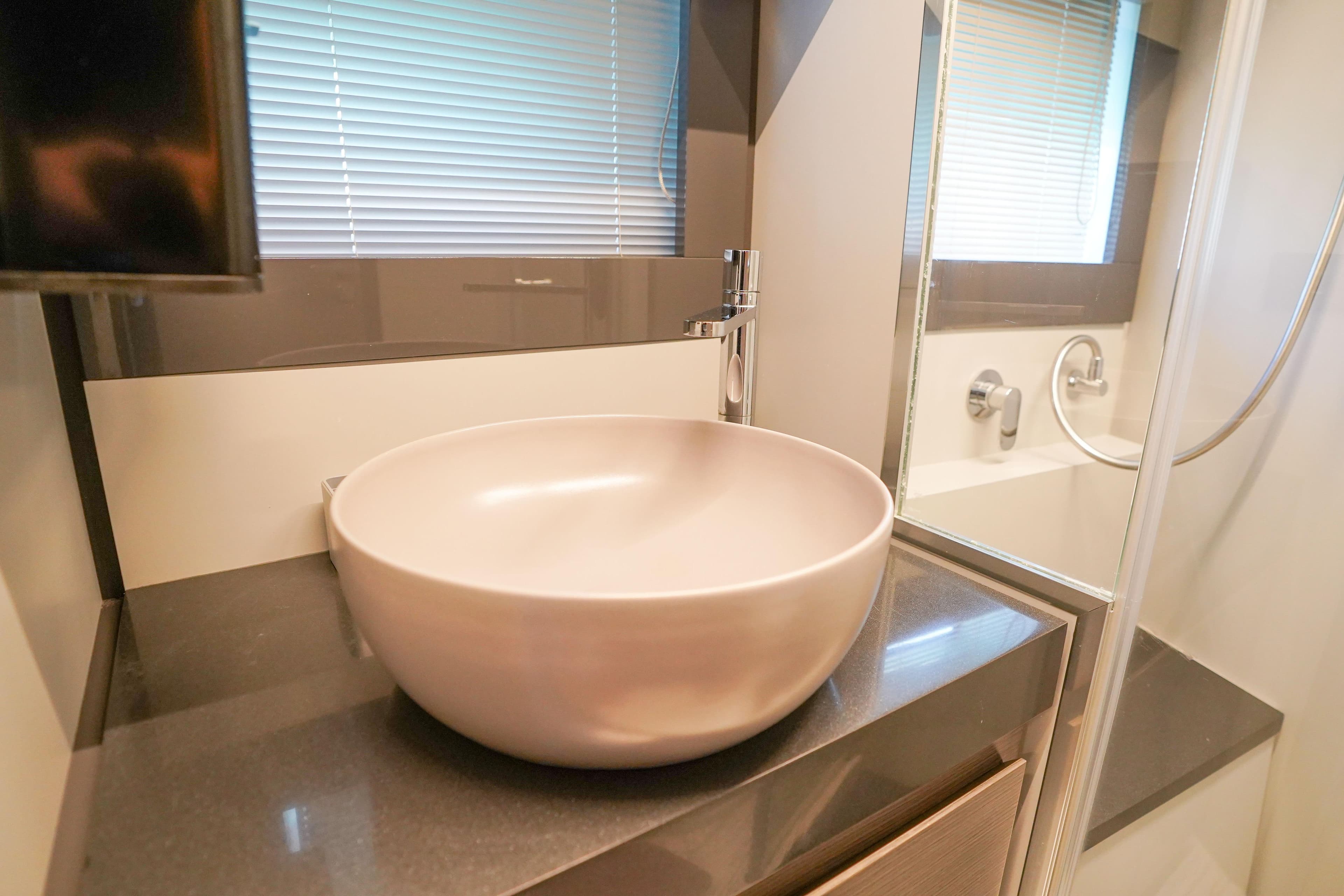 Modern bathroom sink in 2019 Pershing 5x yacht, featuring sleek design and elegant fixtures.