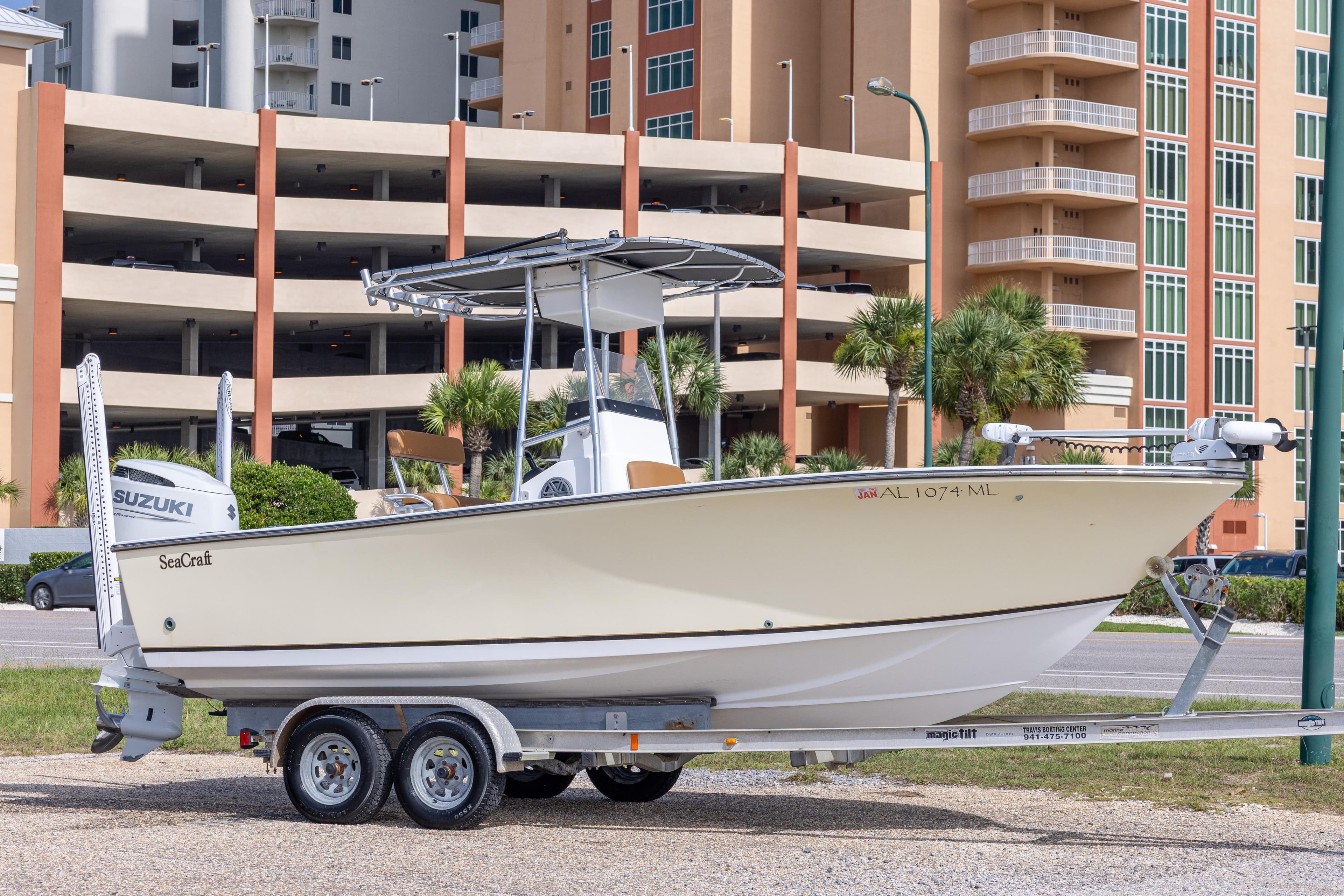 2004 Sea Craft 23 CC boat on trailer, parked near modern buildings.