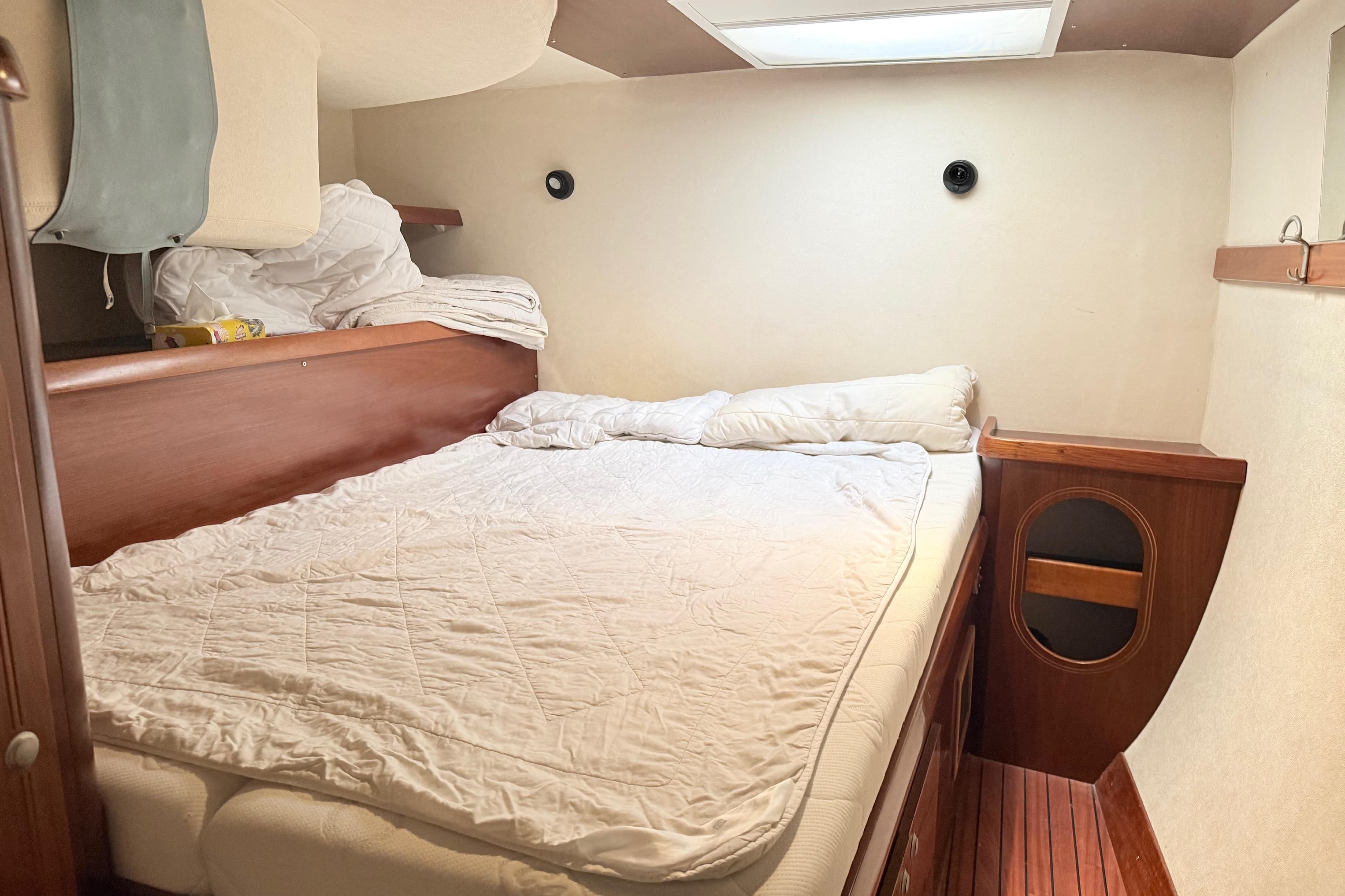 Cozy cabin interior of 2003 Fountaine Pajot Belize 43 catamaran with double bed.