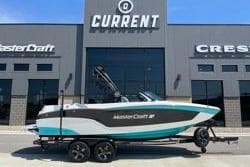 2025 MasterCraft XT22 boat parked outside dealership, showcasing sleek design and modern features.