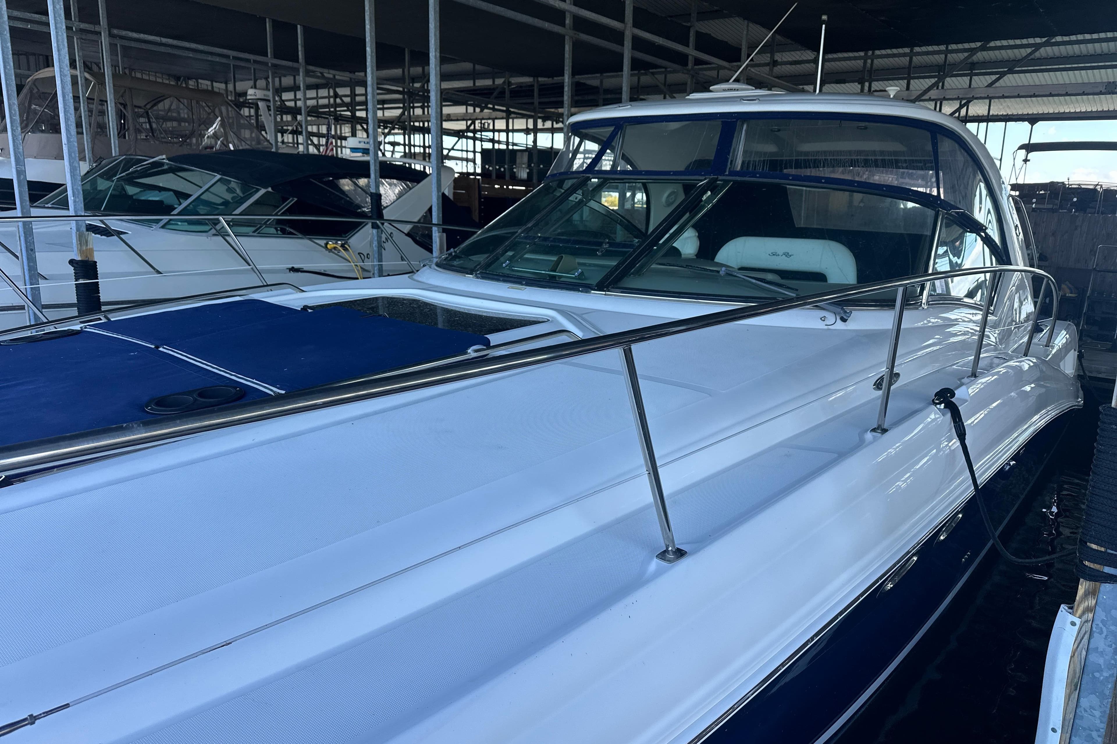 2004 Sea Ray 420 Sundancer yacht docked in a marina, showcasing sleek design and luxury features.