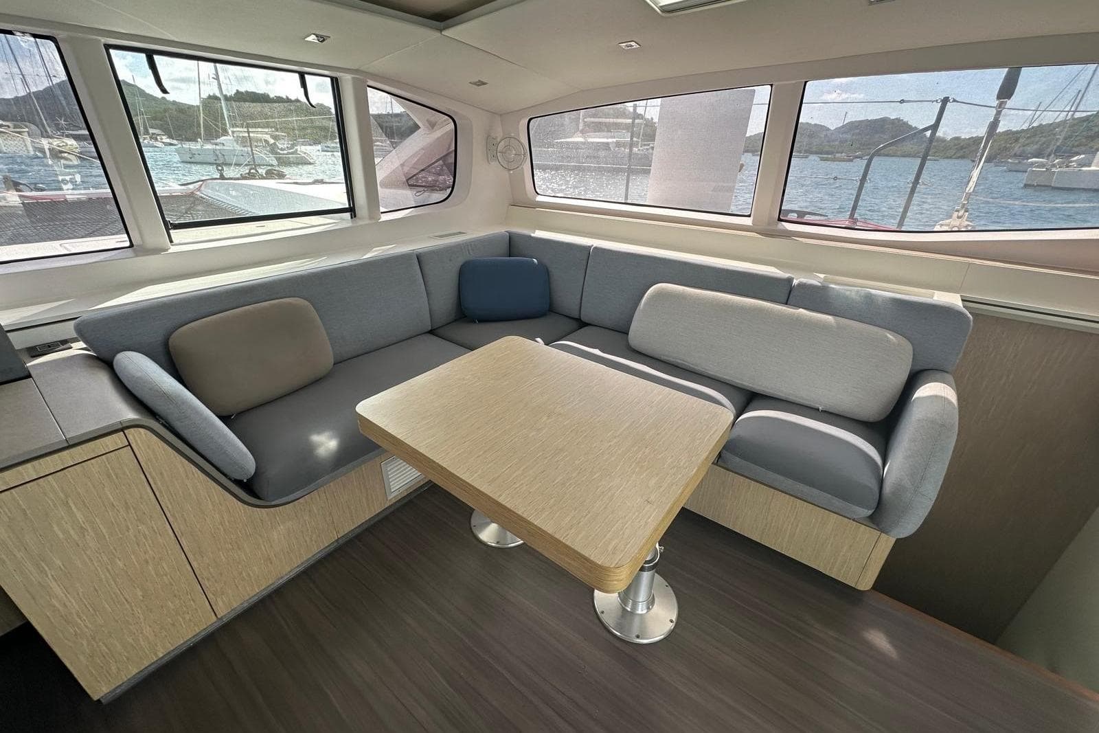 Modern interior of 2021 Outremer 55 yacht with cozy seating and scenic windows.
