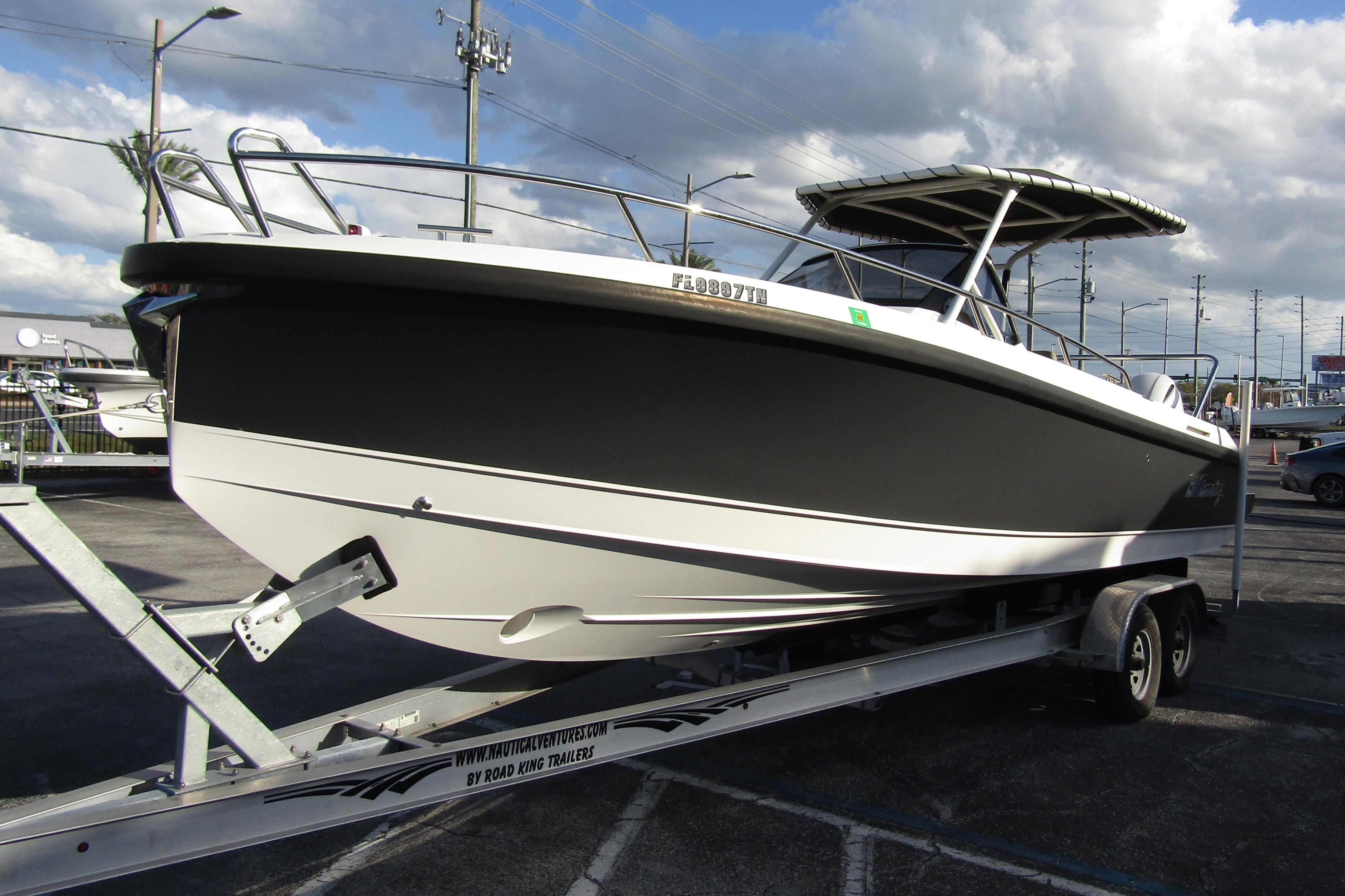 2023 Windy SR28 CC boat on trailer under cloudy sky.