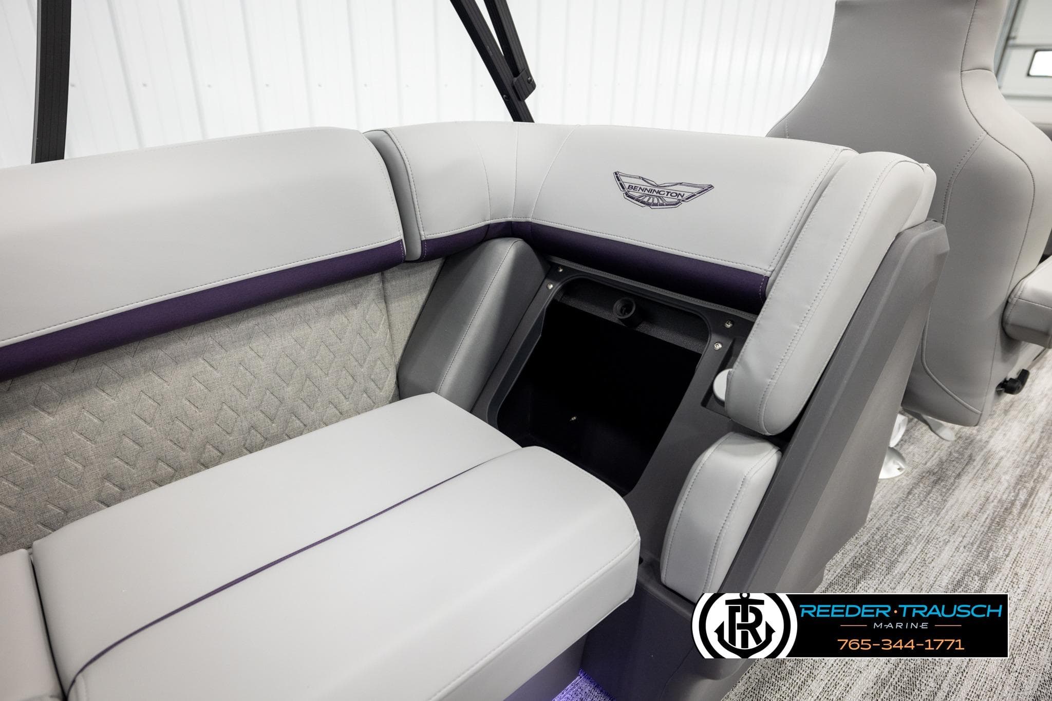 2026 Bennington 22 MFBSE boat interior with gray seating and storage compartment.