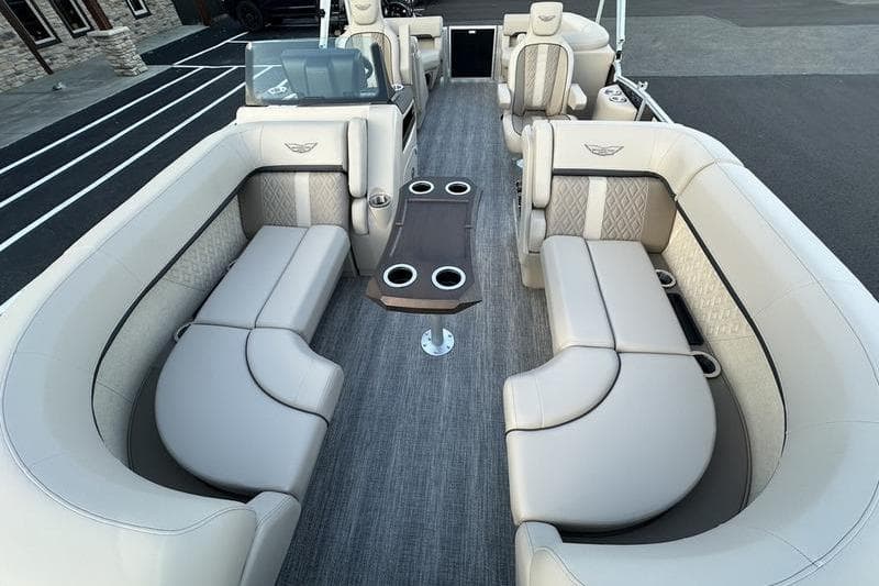 Luxurious 2026 Bennington M Quad Bench 22 MFB pontoon boat interior with plush seating.