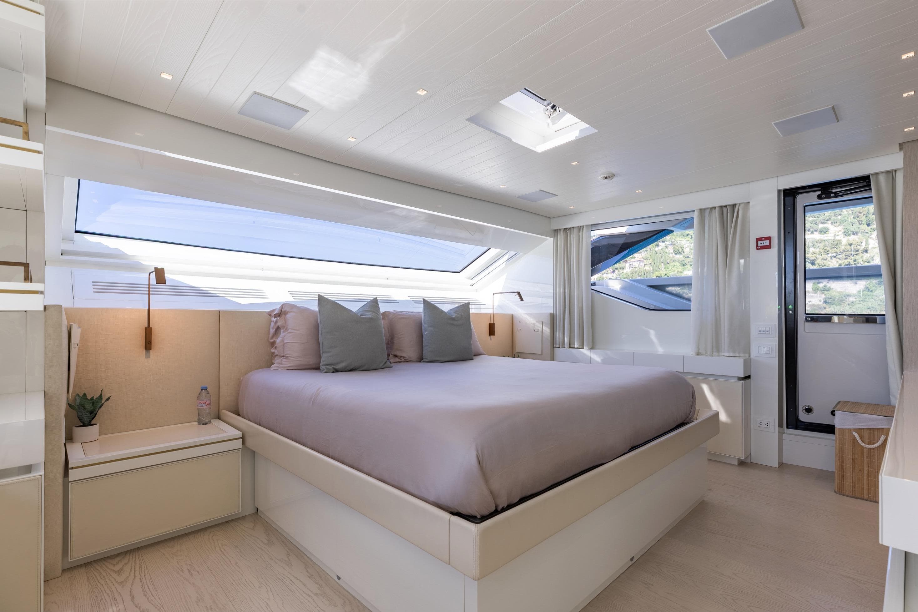 Luxurious bedroom interior of 2022 Sanlorenzo SL106A yacht with modern design and large windows.