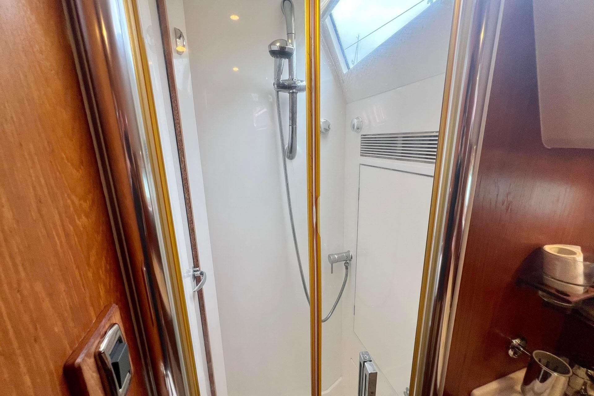 Shower area inside 2014 Southerly 47 yacht, featuring sleek design and modern fixtures.
