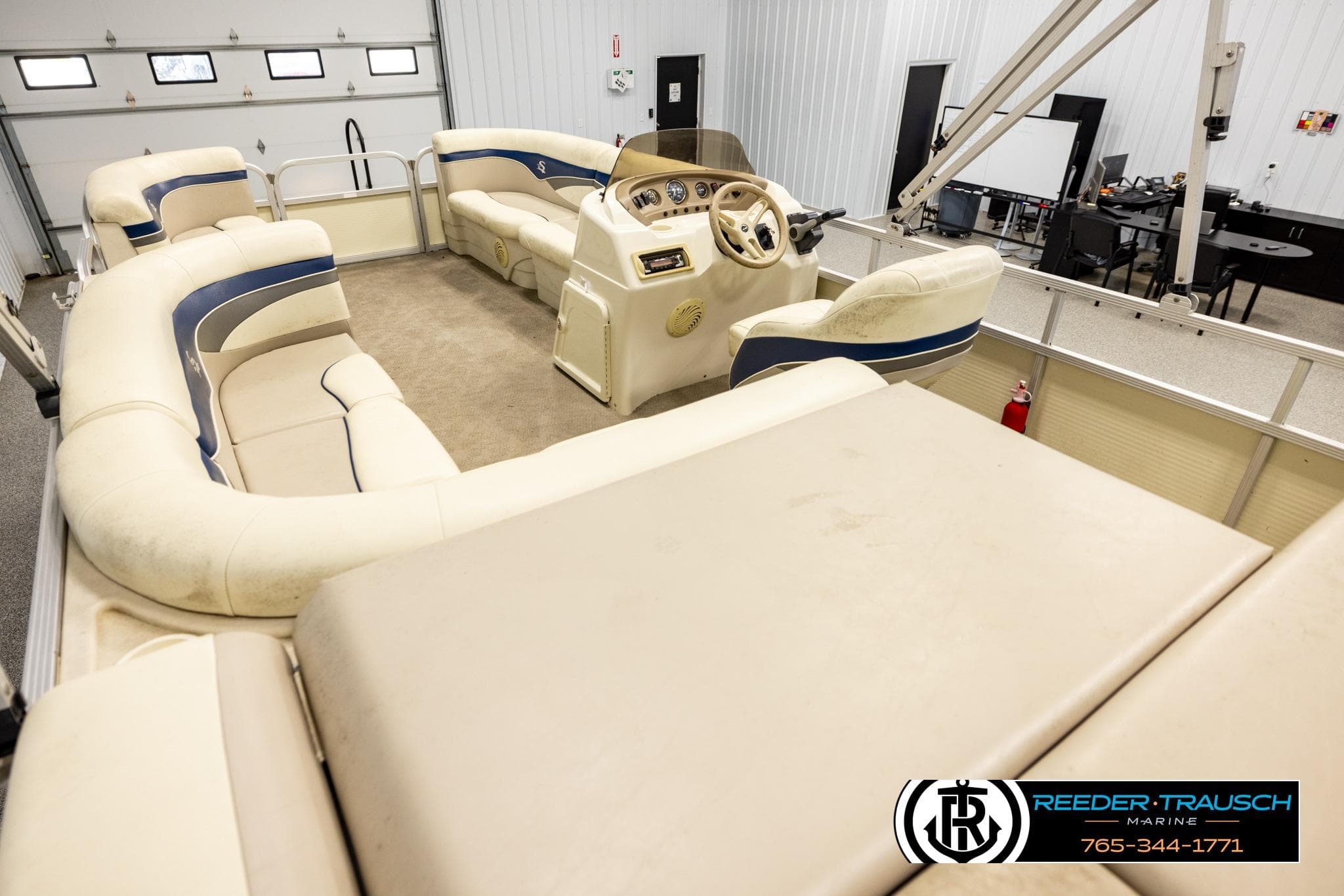 Interior of a 2008 Sedona 20 CR pontoon boat with beige seating and steering console.
