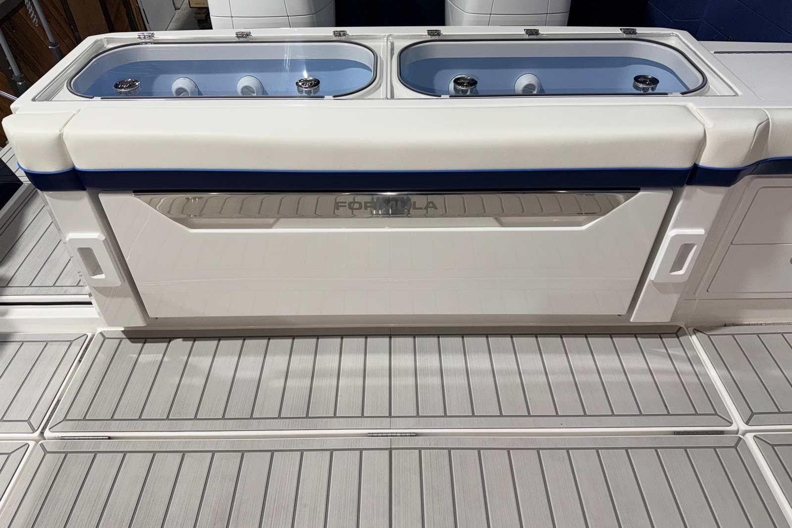 2025 Formula 387 Center Console Fish boat with dual livewells on deck.