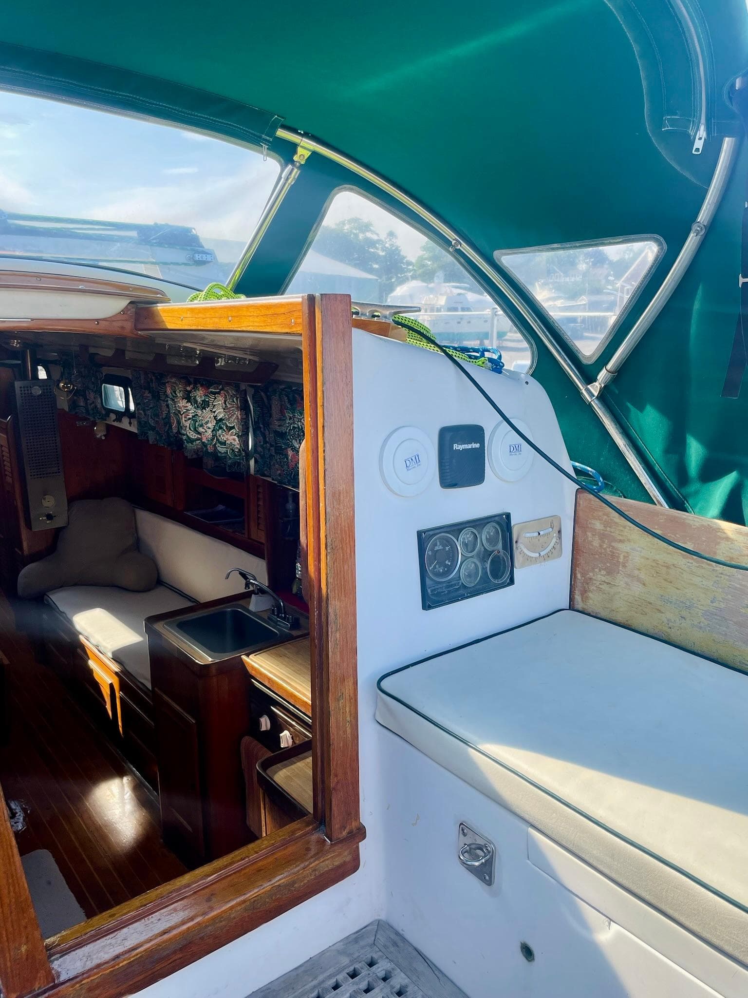 1981 Bristol 40 sailboat interior with green canopy and wooden accents.