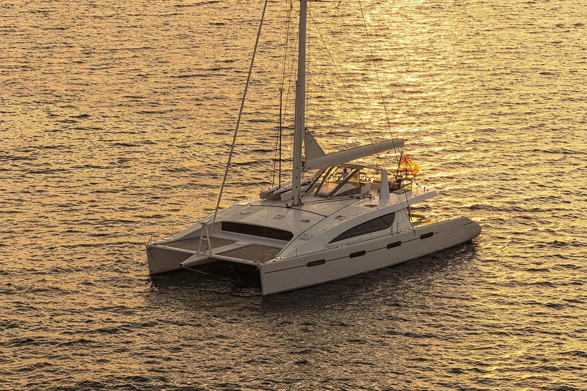 Luxury Matrix Yachts Silhouette 760 catamaran sailing at sunset, 2007 model.