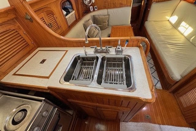 1986 Fairweather Mariner 39 yacht interior with dual sinks and wooden cabinetry.