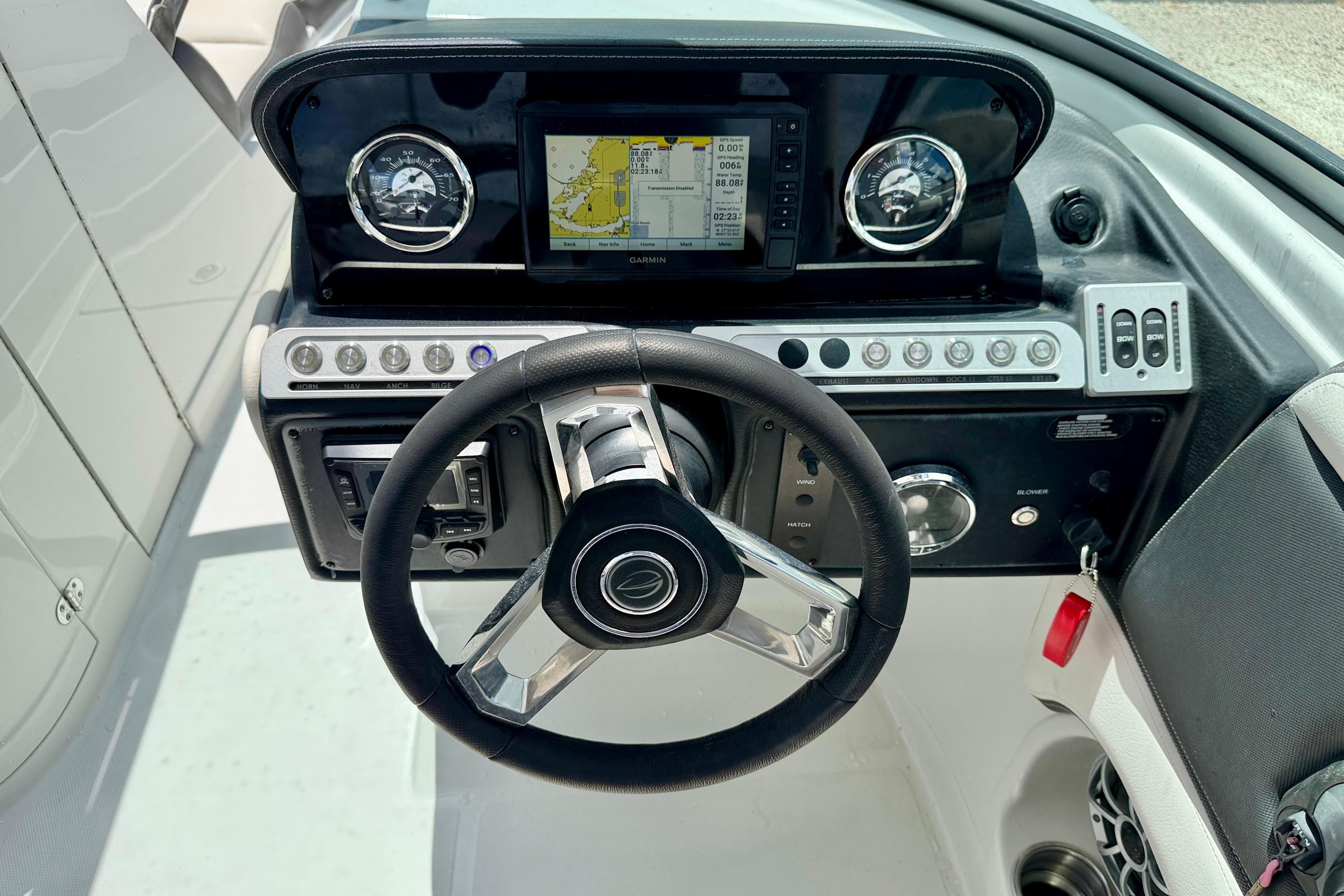 2022 Crownline 260 XSS boat dashboard with steering wheel and Garmin navigation system.