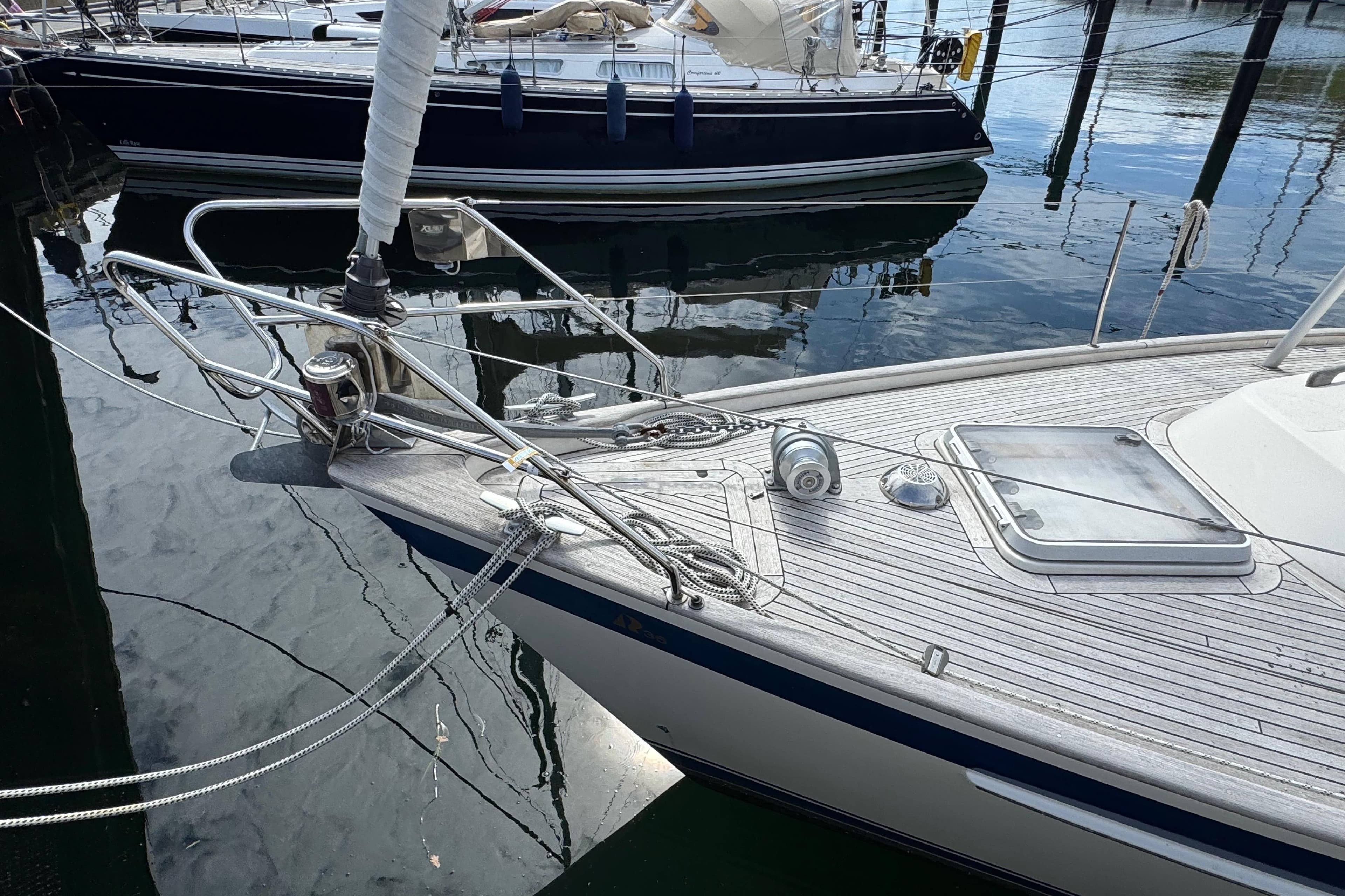 Bow of 1997 Hallberg-Rassy 36 MKII sailboat docked in marina.