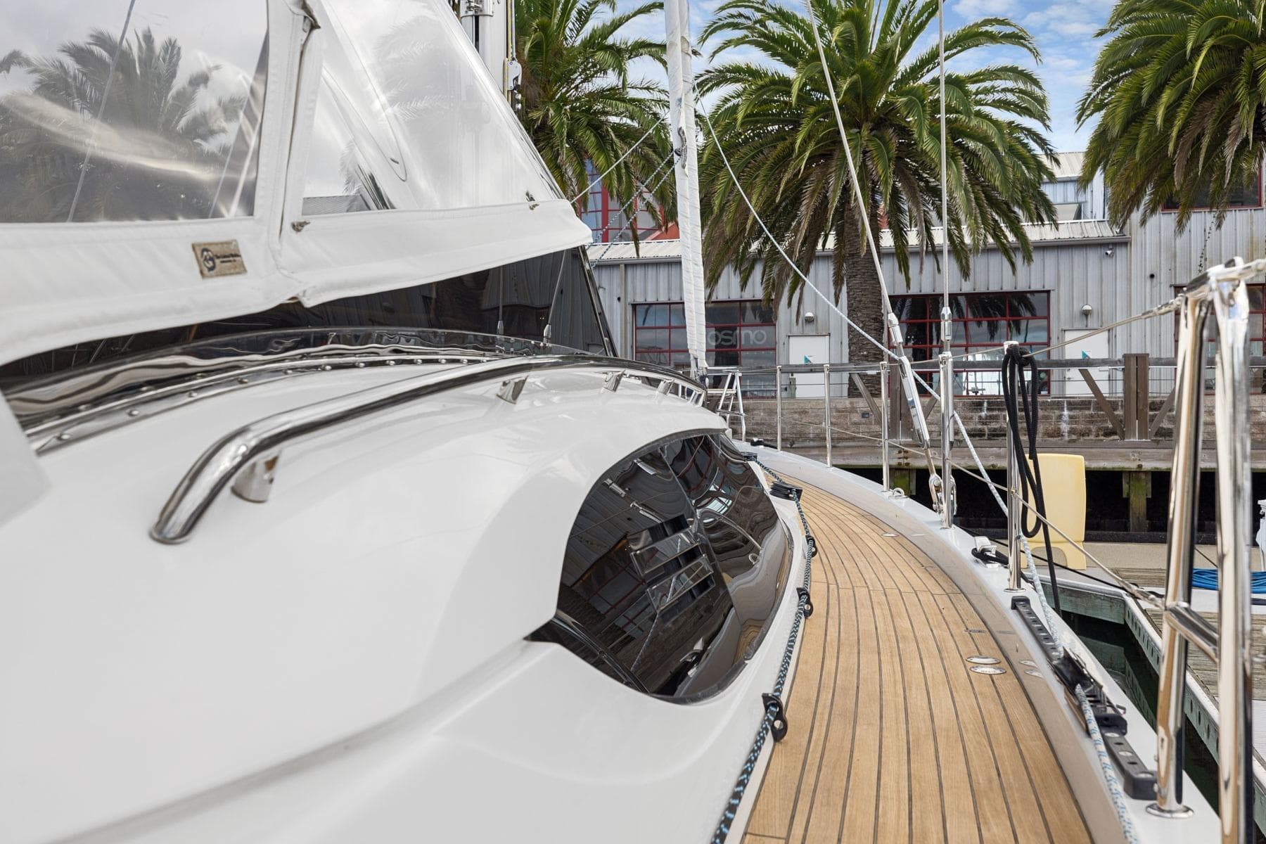 2020 Hylas H57 yacht docked, showcasing sleek design and wooden deck.