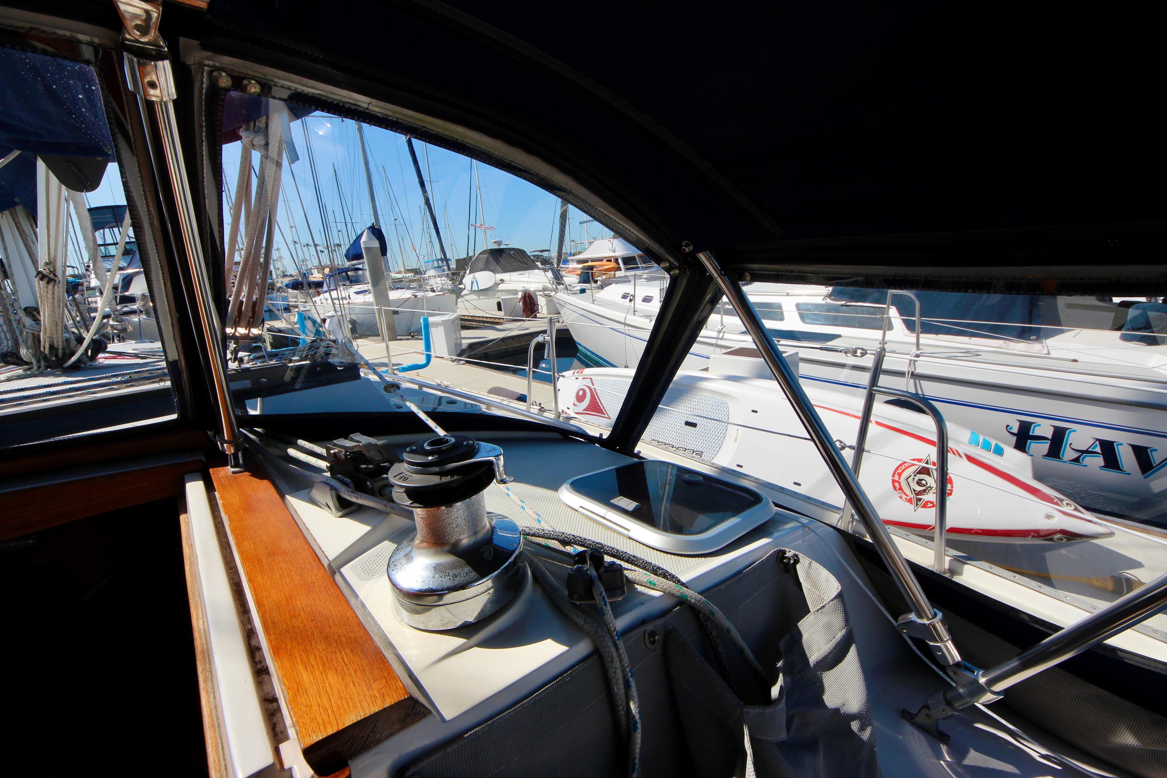 Cockpit view of a 1993 Catalina 42 MKI sailboat docked at a marina.