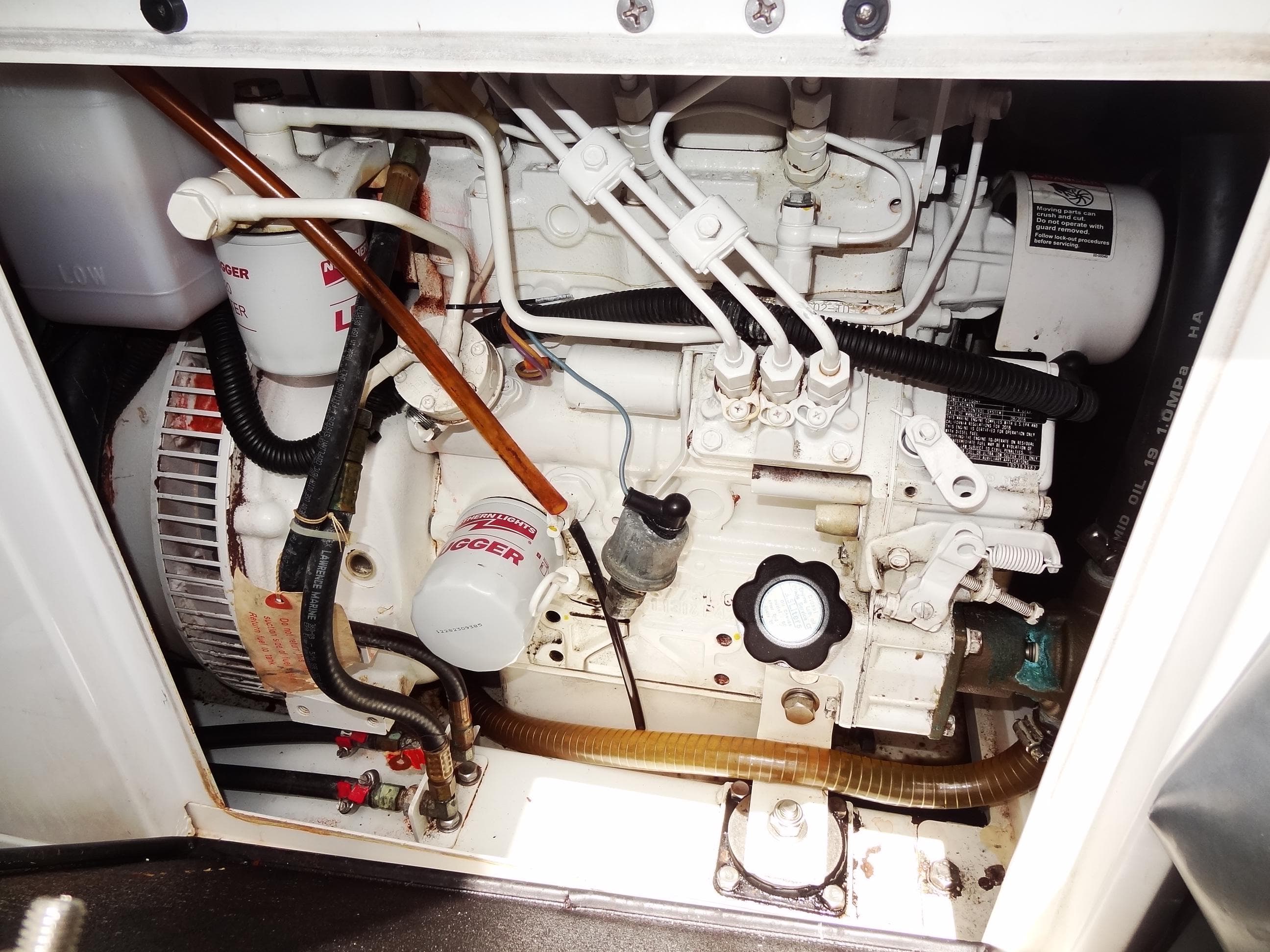 Engine compartment of a 2020 Leopard 45 yacht, showcasing mechanical components and wiring.