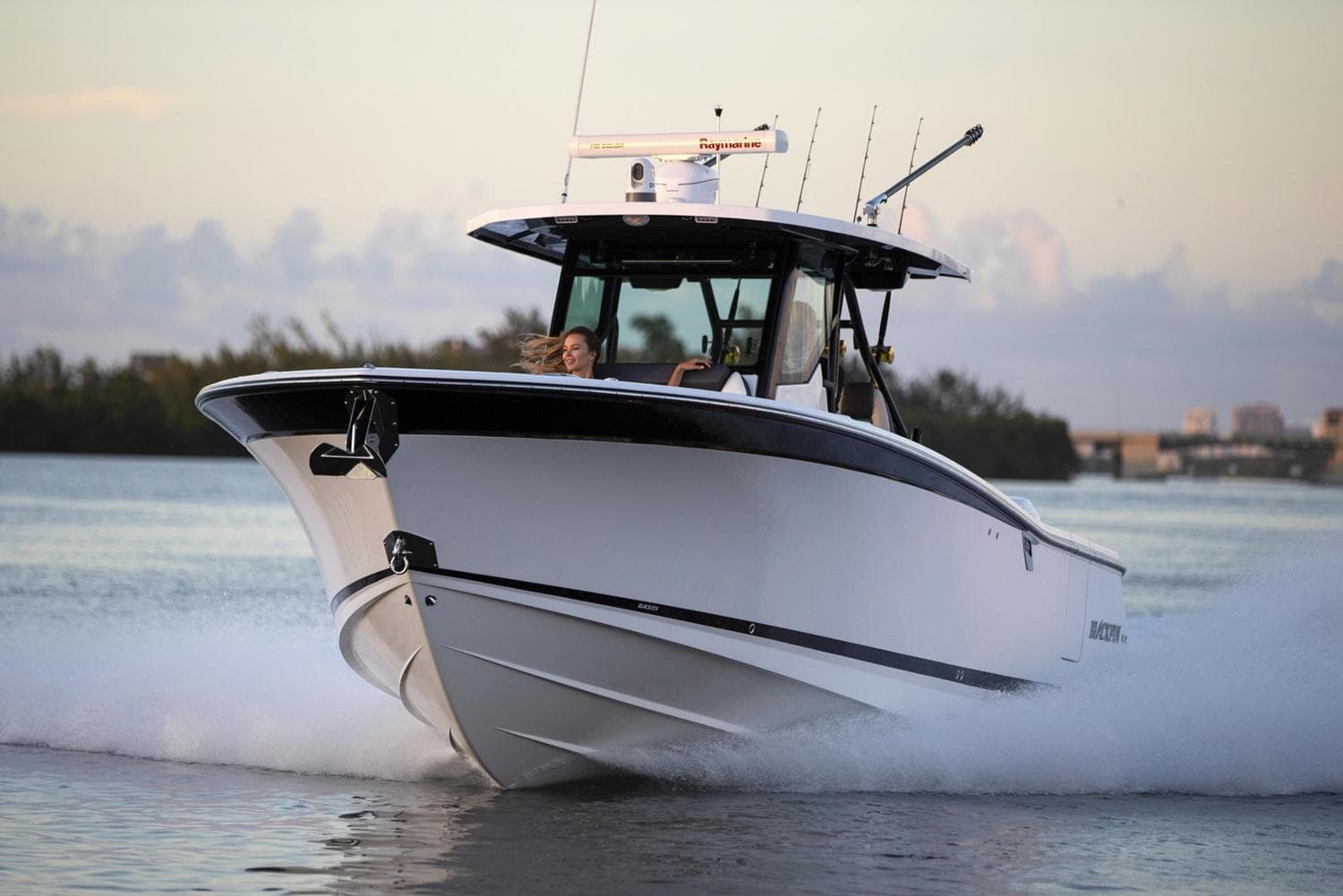 Manufacturer Provided Image: 2026 Blackfin 332 CC boat cruising on water at sunset.
