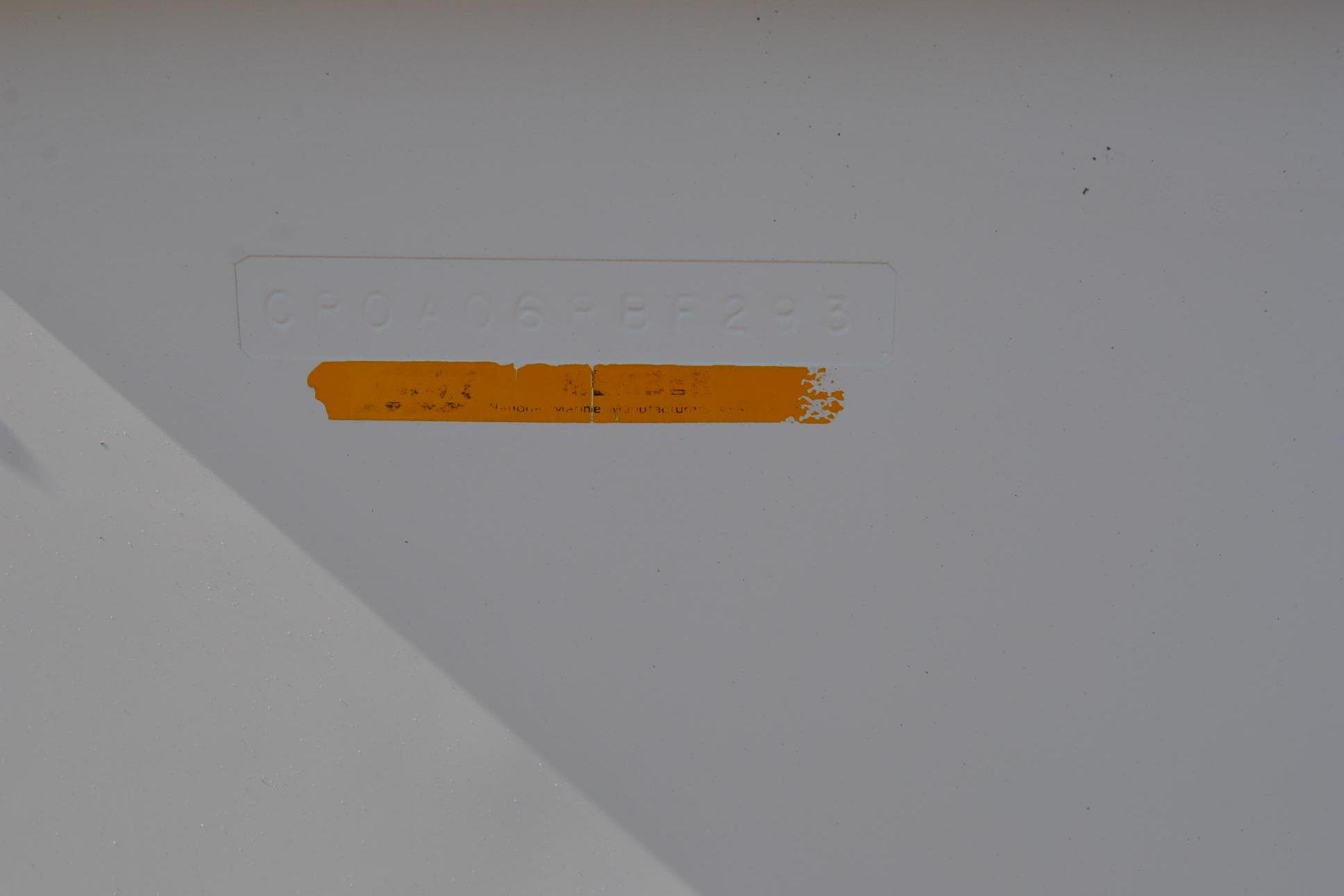 1993 Robalo 2120 Center Console hull identification number with faded orange label.