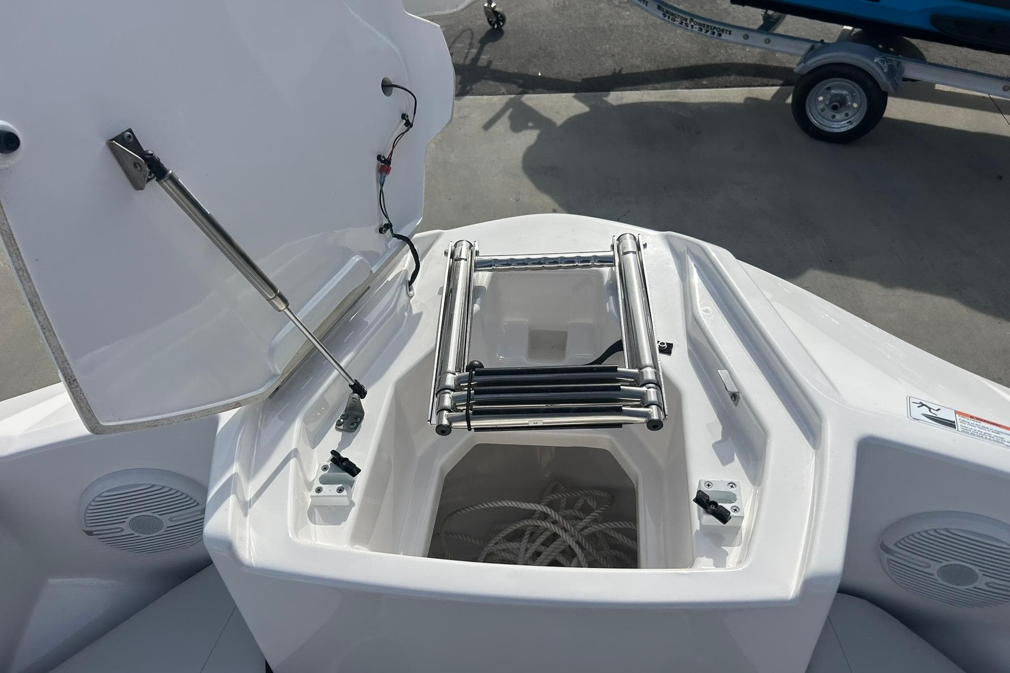 2024 Yamaha Boats AR220 bow storage with ladder and speakers.