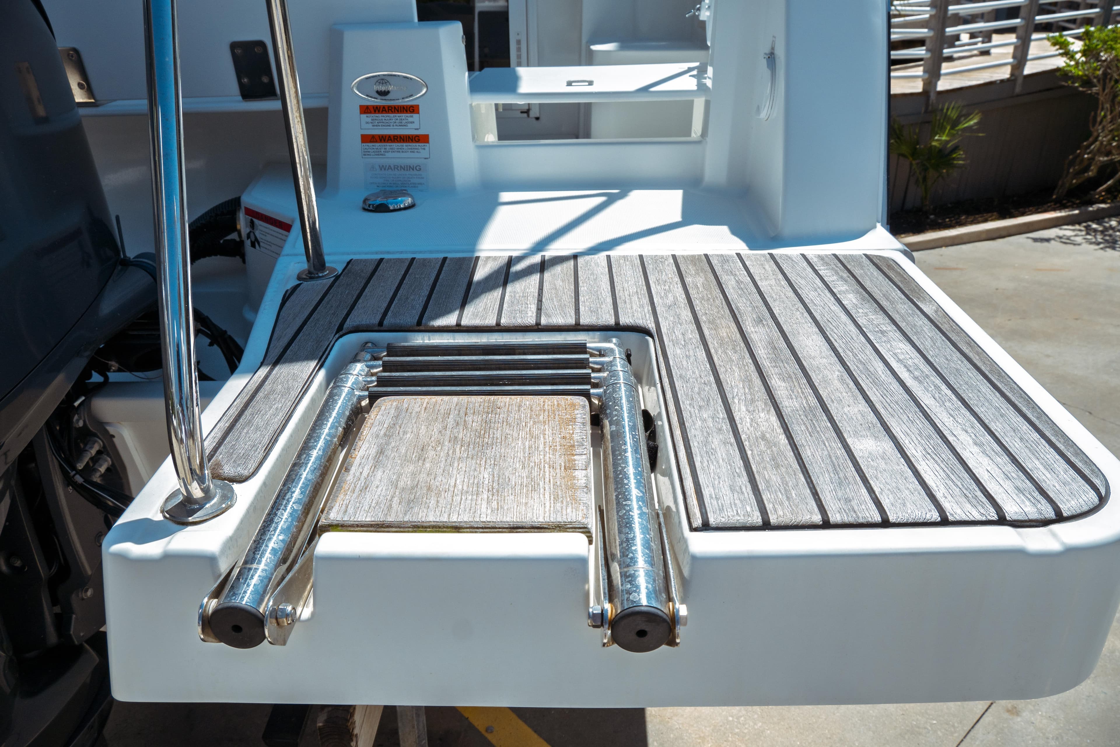 2023 Jeanneau NC Weekender 795 Series 2 swim platform with ladder and wood finish.