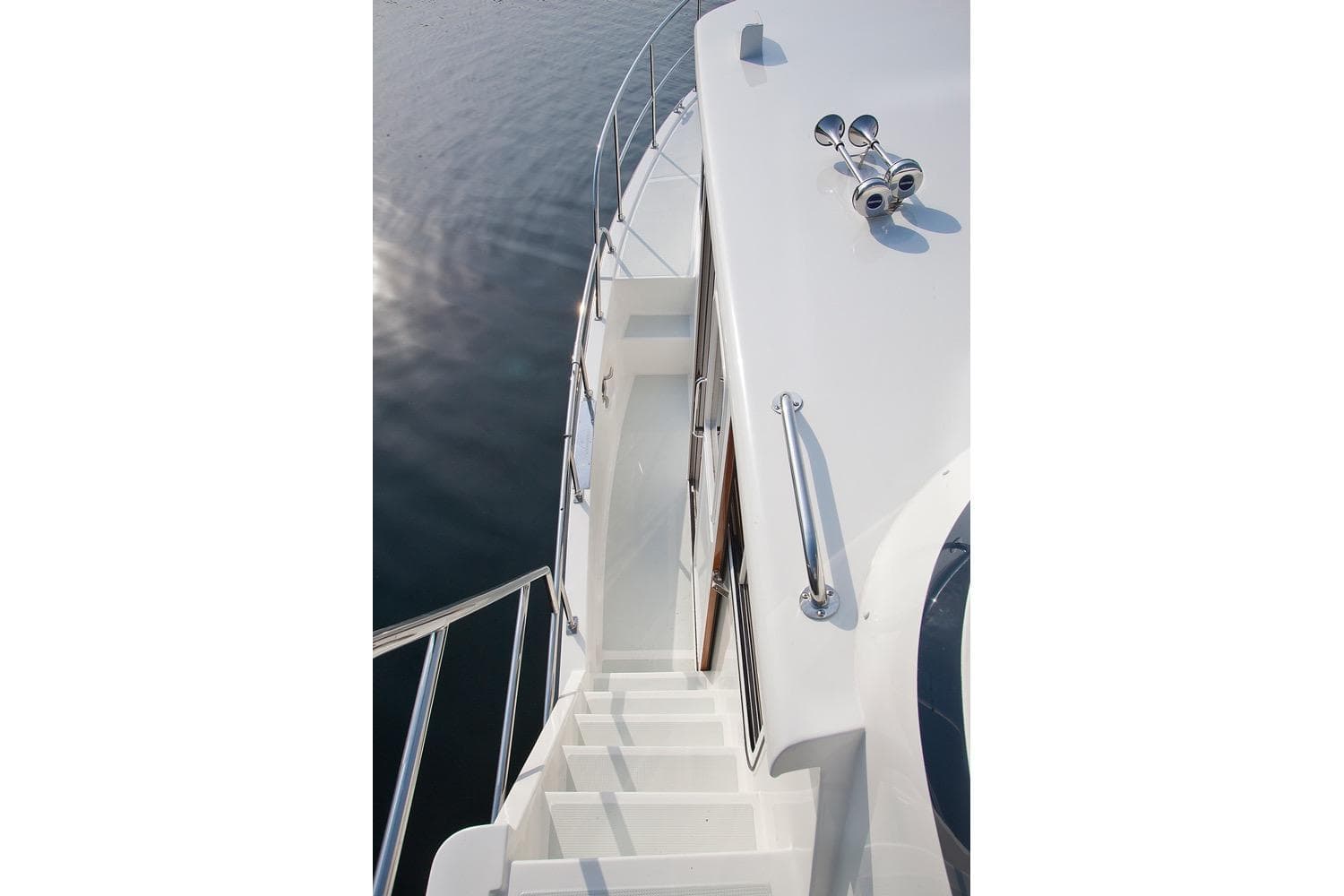 Stairway on 2026 Helmsman Trawlers 43 Pilothouse yacht, featuring sleek design and chrome details.
