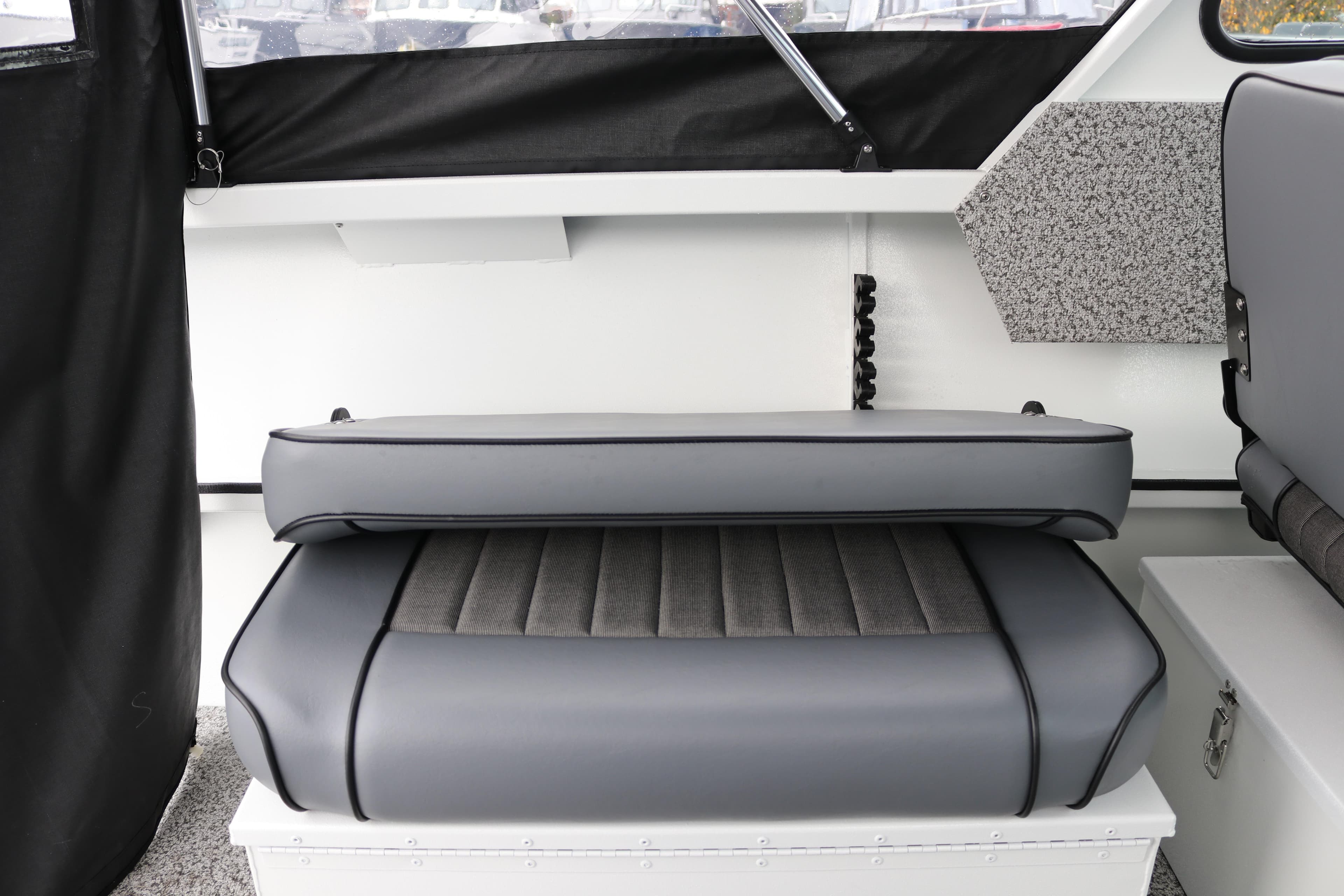 Interior seating of 2026 Alumaweld Stryker 202 boat, featuring gray cushioned seats.