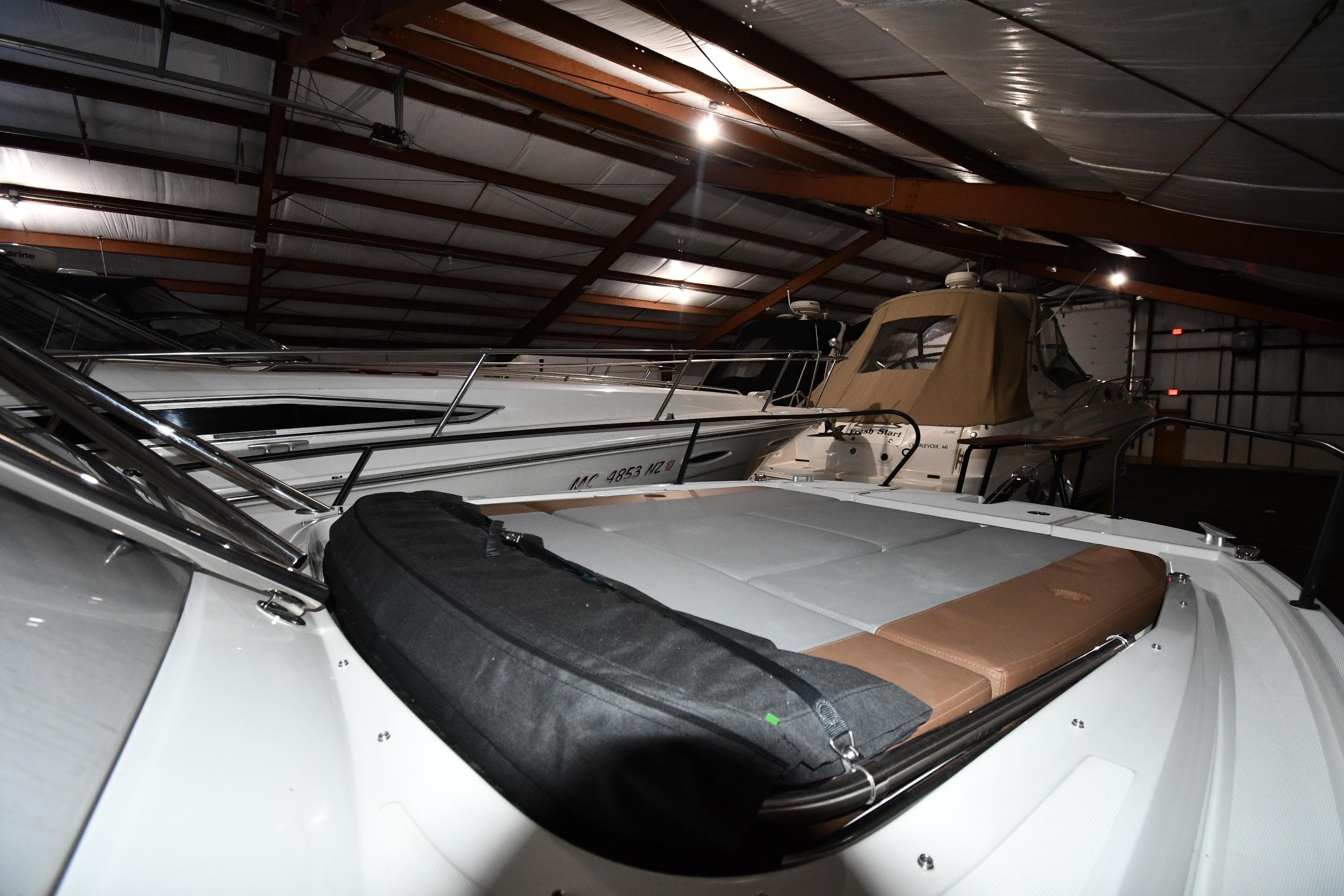2023 Beneteau Flyer 9 SUNdeck in a dimly lit storage facility.