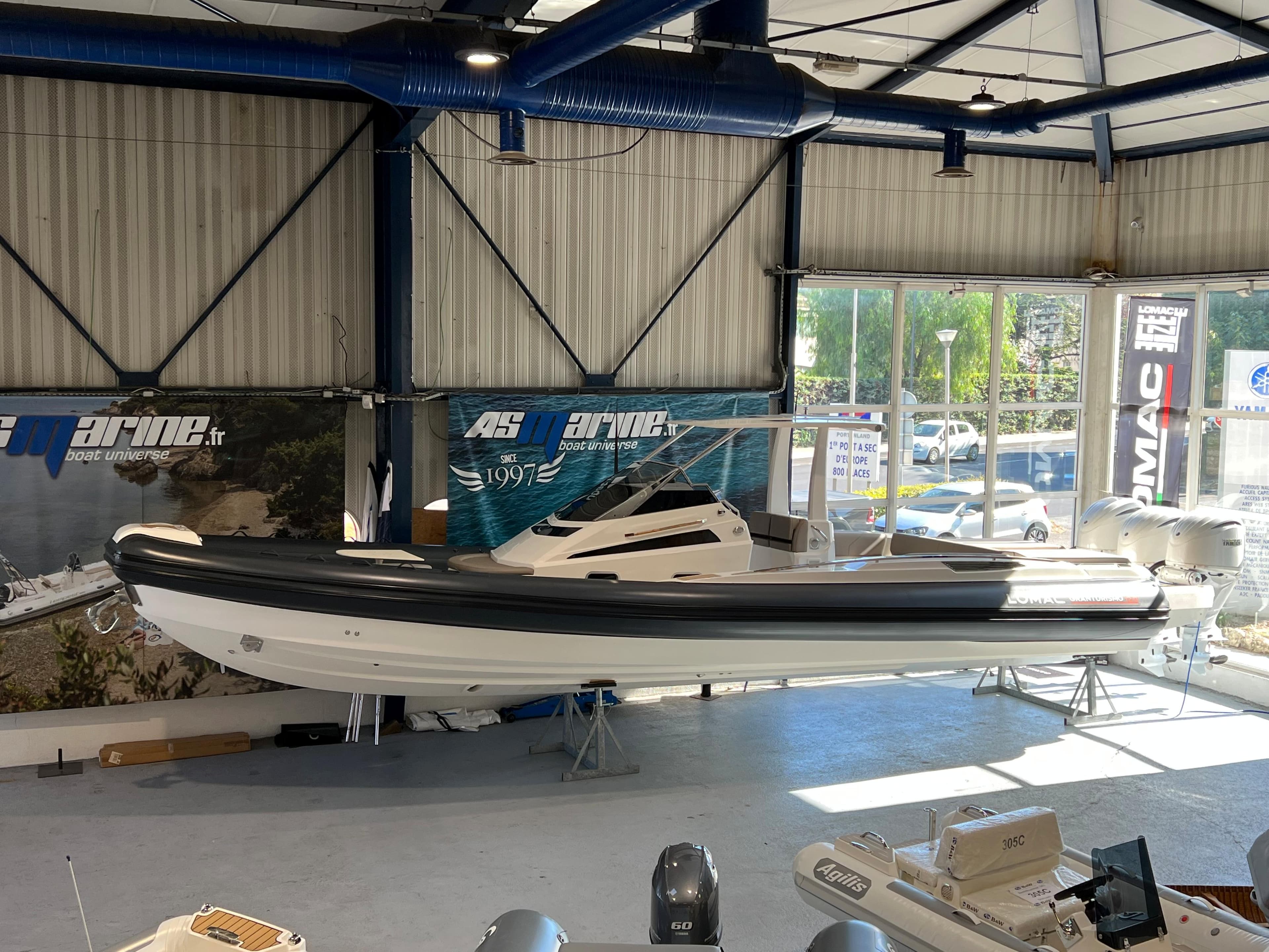 2023 Lomac GranTurismo 12.0 boat displayed in a showroom.