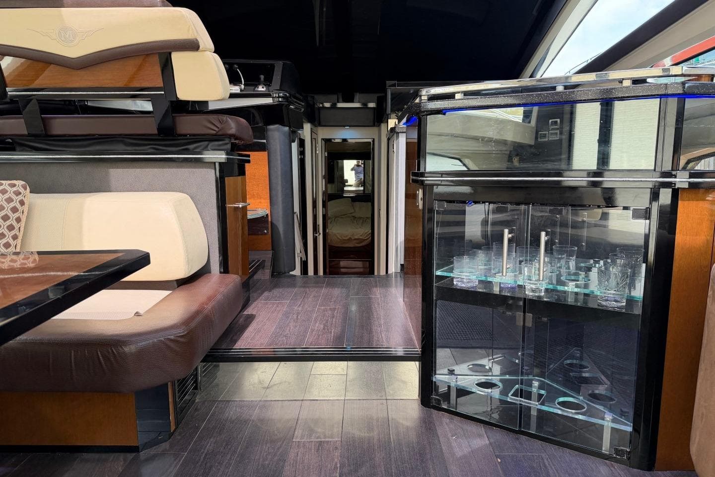 Luxurious interior of a 2009 Marquis 500 Sport Coupe yacht with elegant seating and glass cabinet.