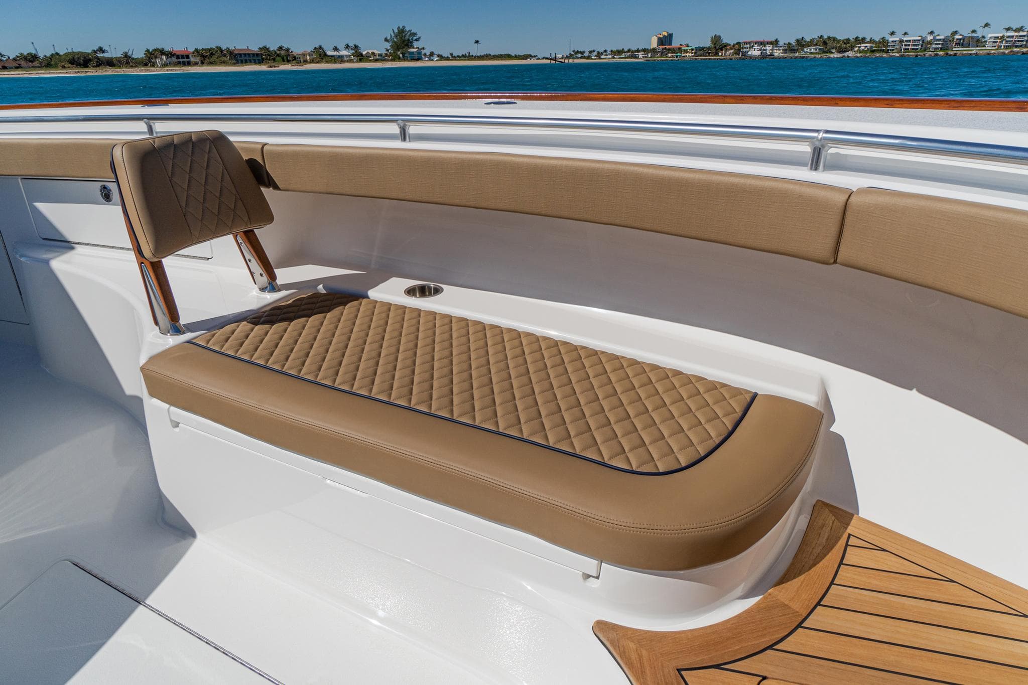 2025 Valhalla Boatworks V-46 interior with tan quilted seating and ocean view.