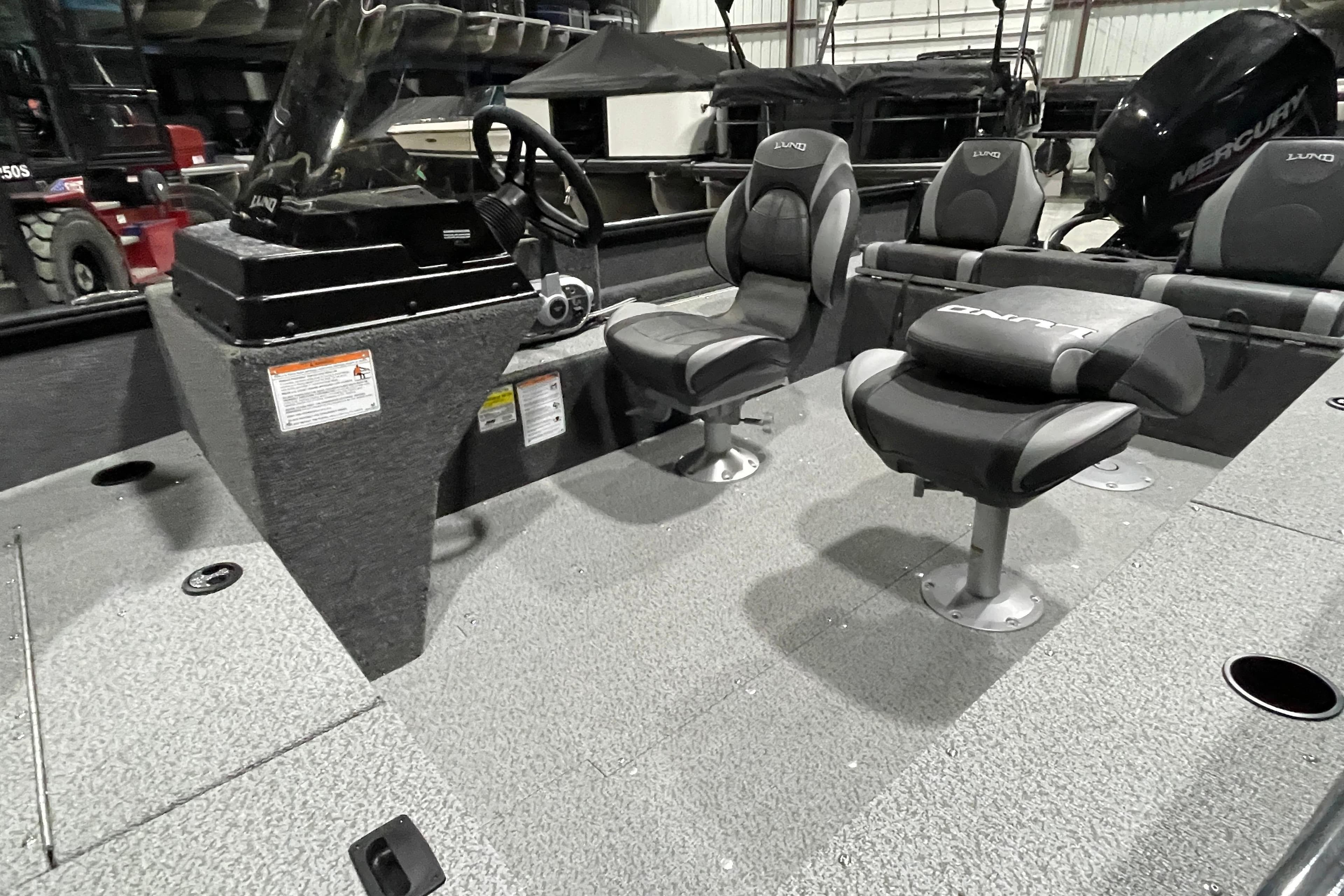 2026 Lund 1650 Rebel XL SS boat interior with seating and steering console.
