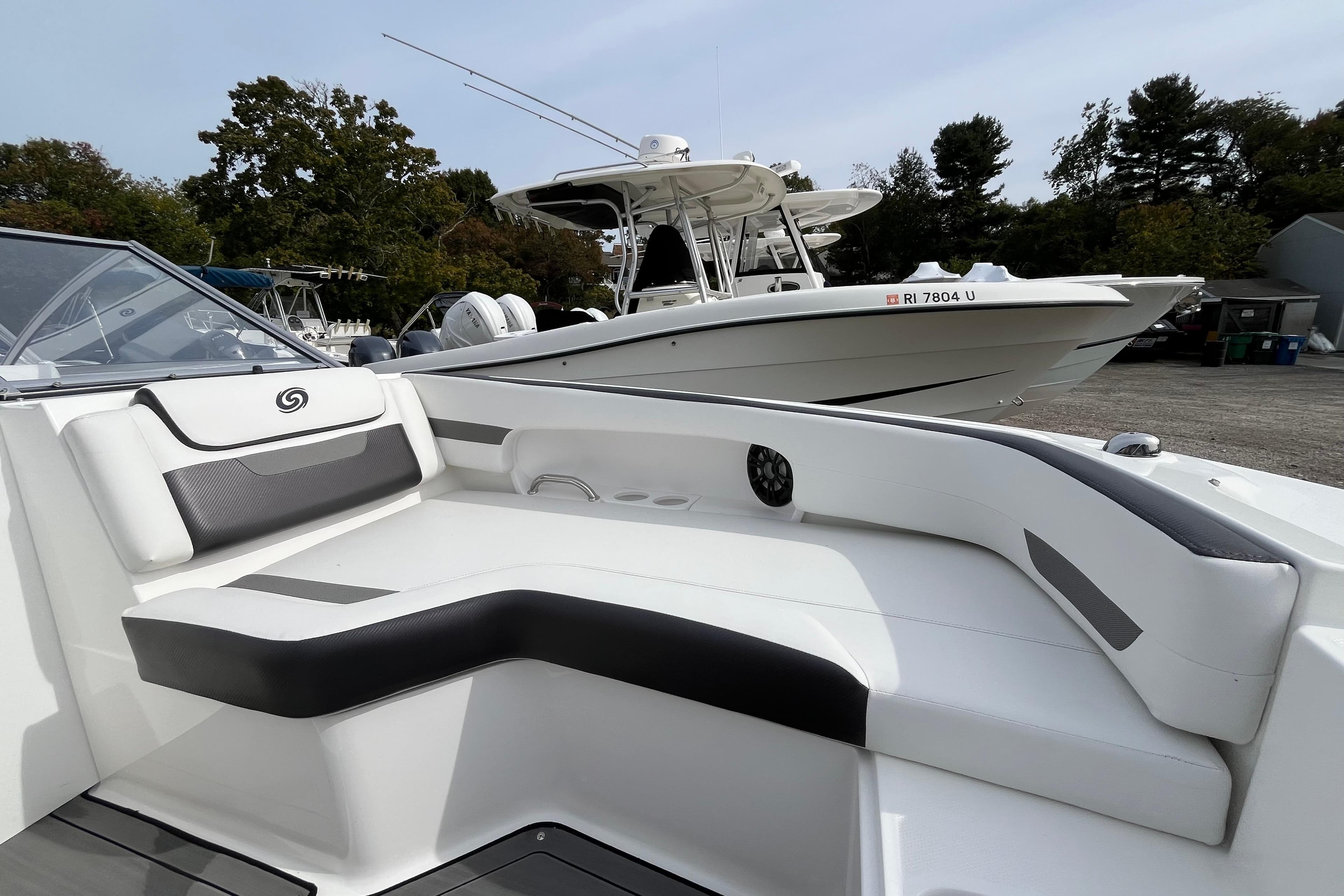 2023 Hurricane SunDeck 235 OB boat with sleek seating and modern design.