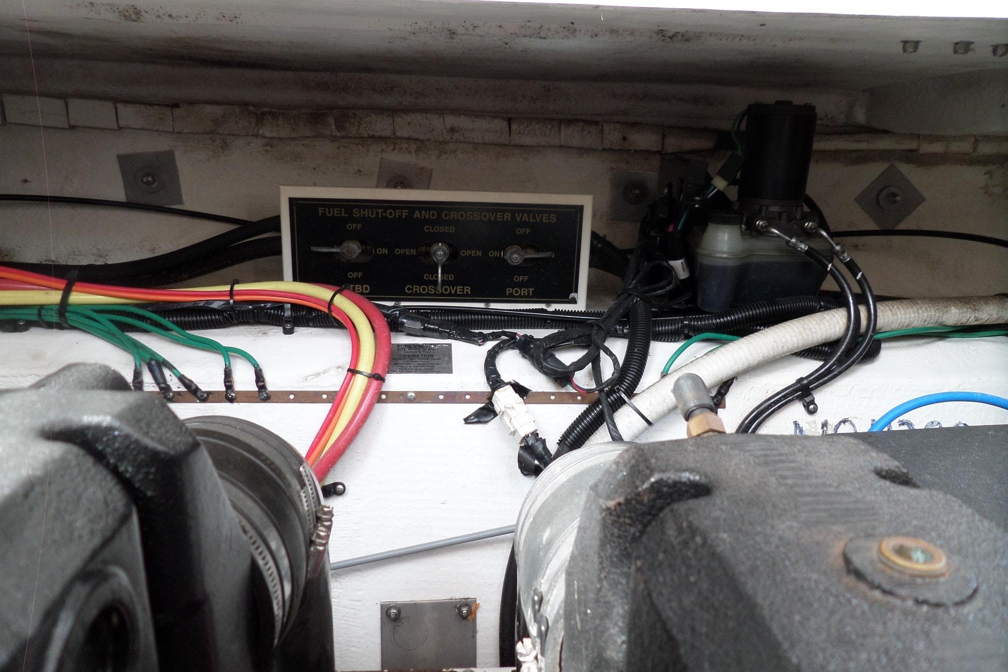 Engine compartment of 2003 Cruisers Yachts 3275 Express with fuel shut-off and crossover valves.