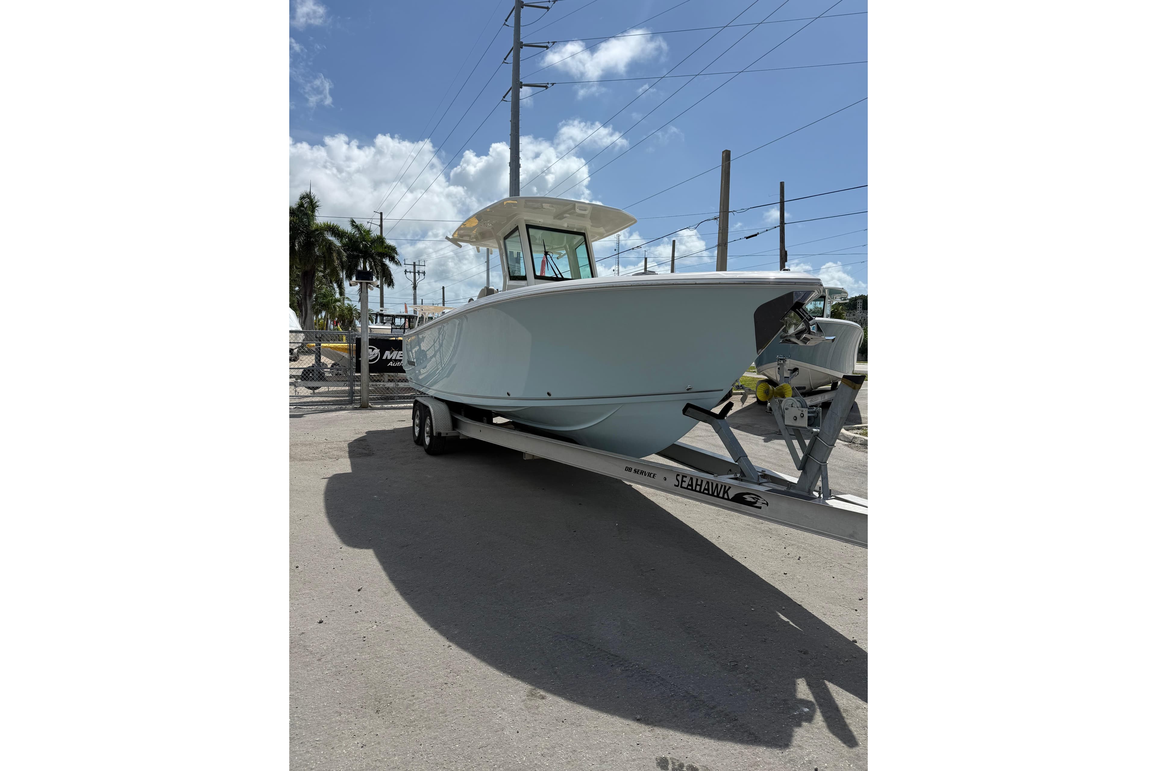 2026 Sailfish 272 CC boat on trailer under clear blue sky.