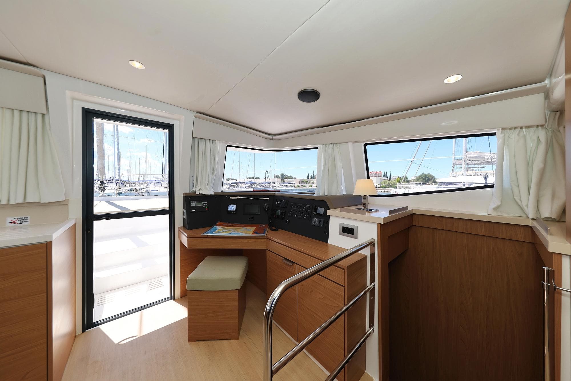 Interior of 2025 Bali 4.4 yacht with navigation station and panoramic windows.