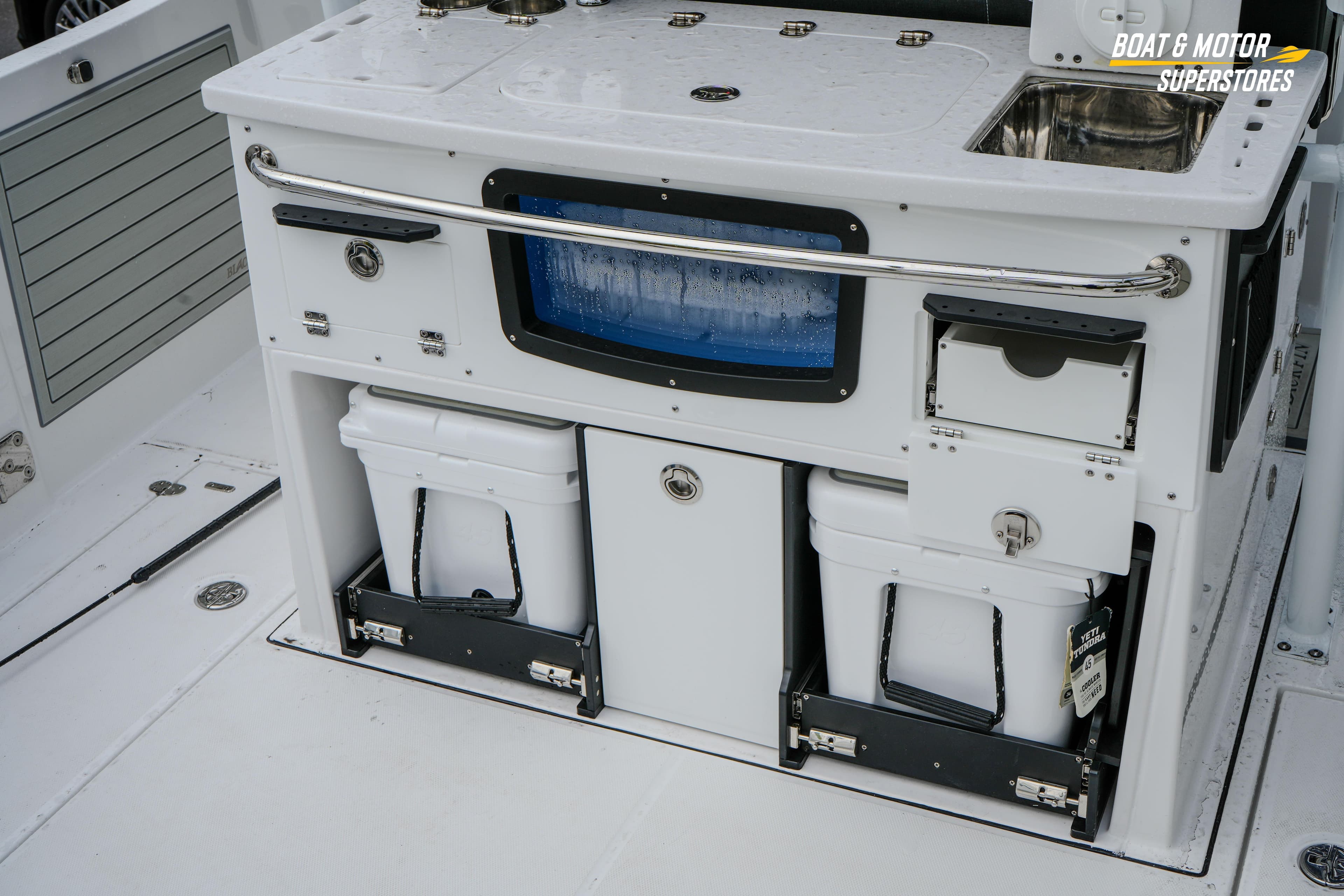 2026 Blackfin 332 CC boat interior with storage compartments and sink.